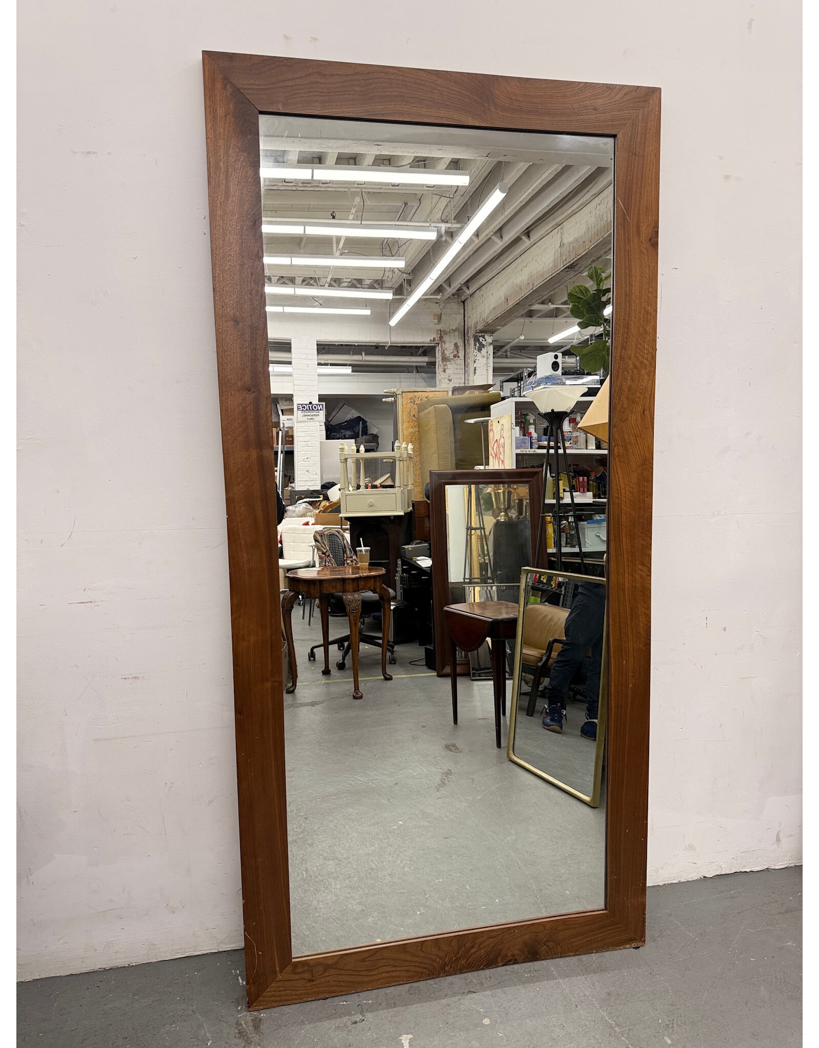 mid-century modern style rectangular mirror with a dark wood frame