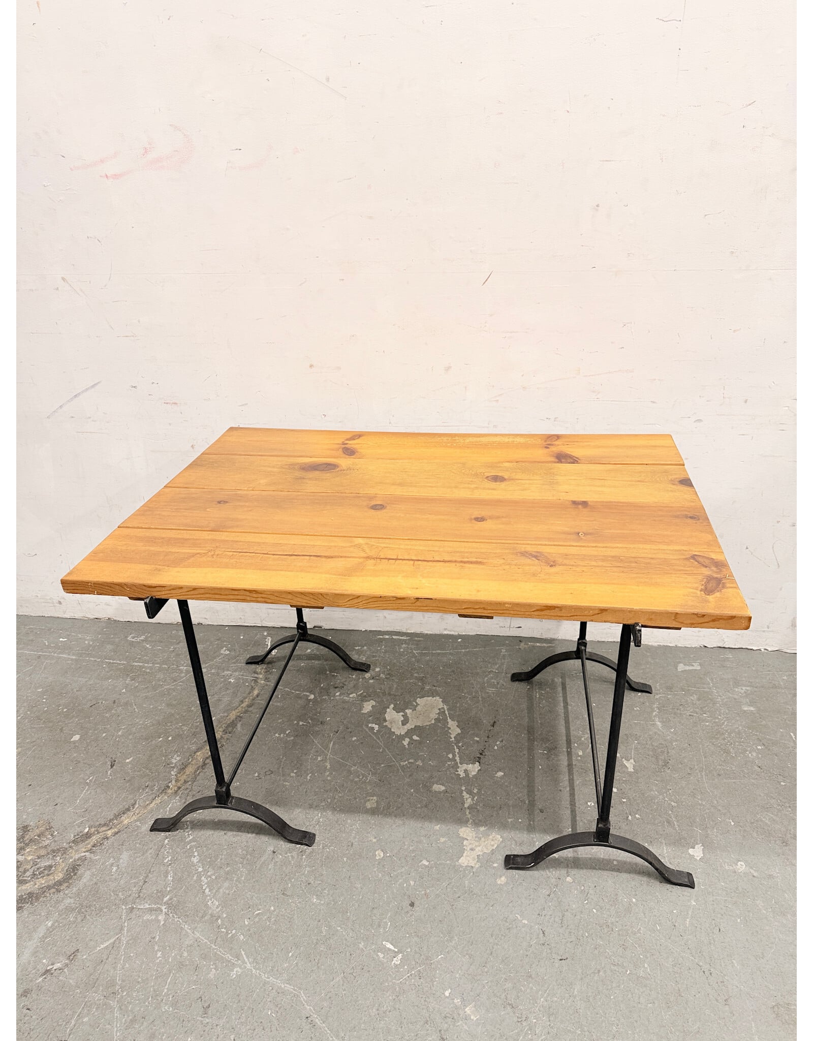 Rustic Wooden Plank-Top Table with Black Iron Trestle Base