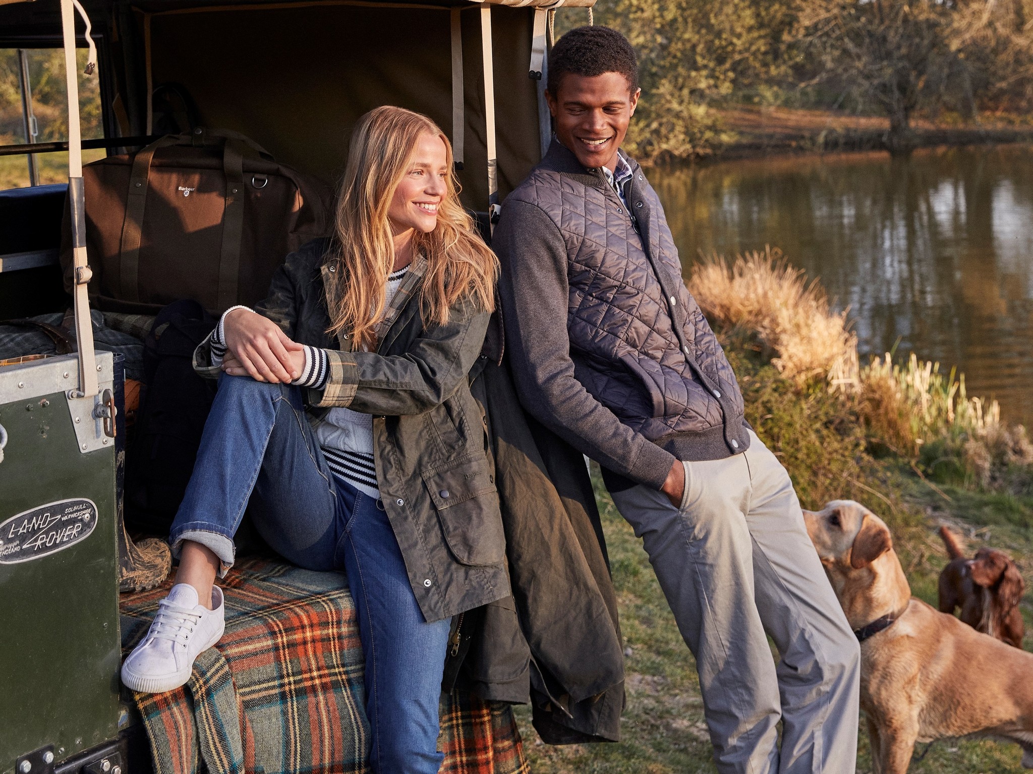 Couple in back of camper wearing Barbour jackets