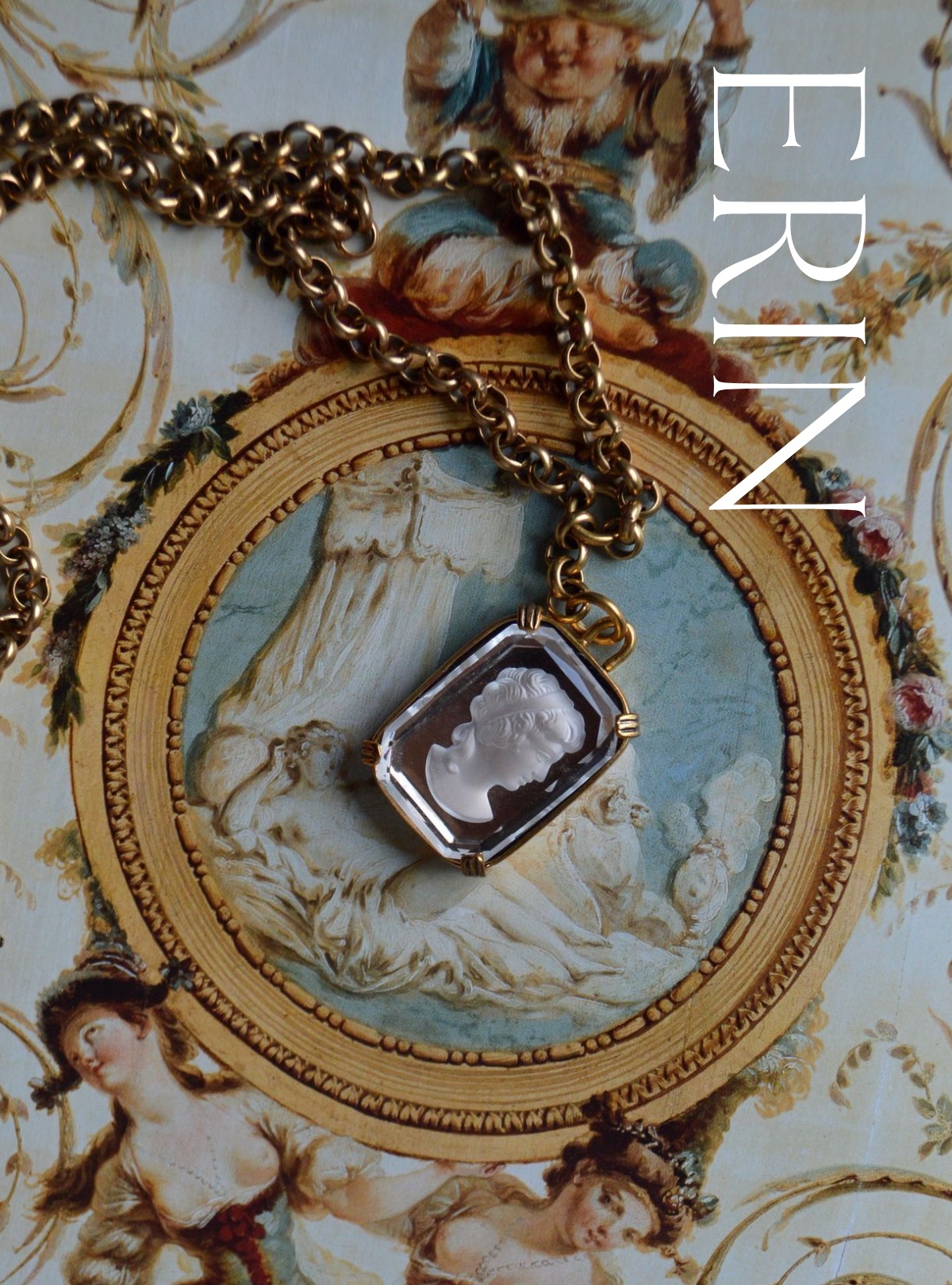 A French palace ceiling is painted in the backdrop of this image beside the name "Erin." Our glass cameo necklace drapes across its front, described below.