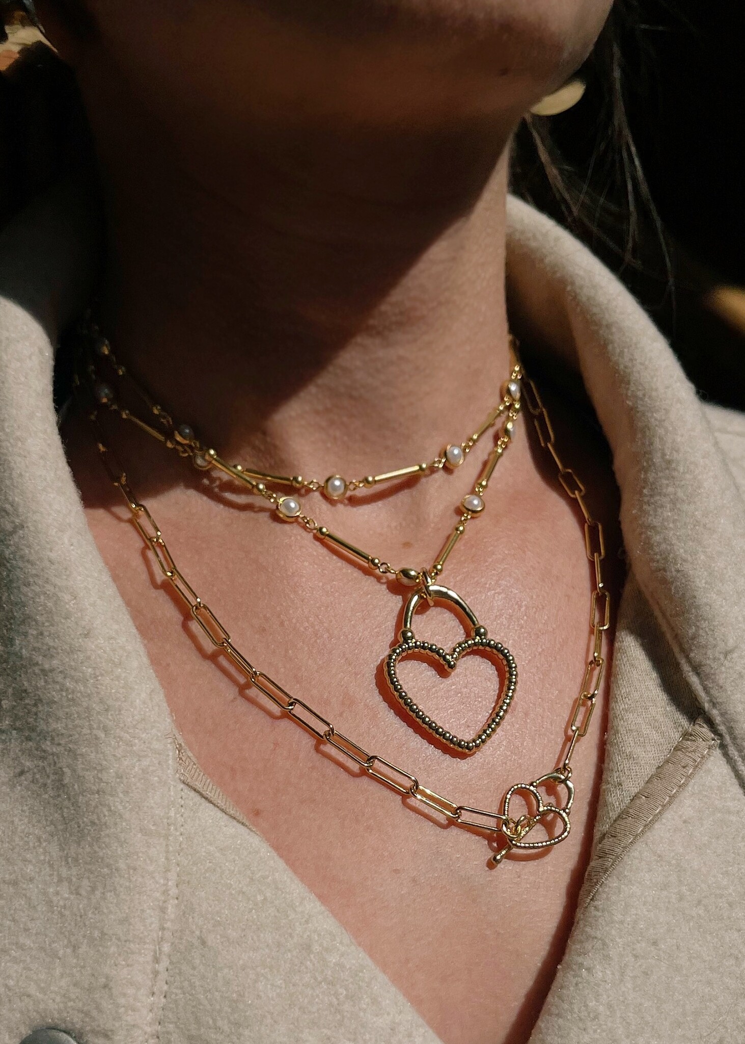 Carine heart necklace around a woman's neck