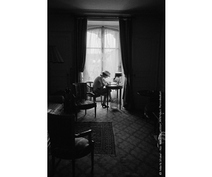 Mark Shaw Photography - Coco Chanel Writes at Desk in Window, Head Down 1957  - Becker Minty