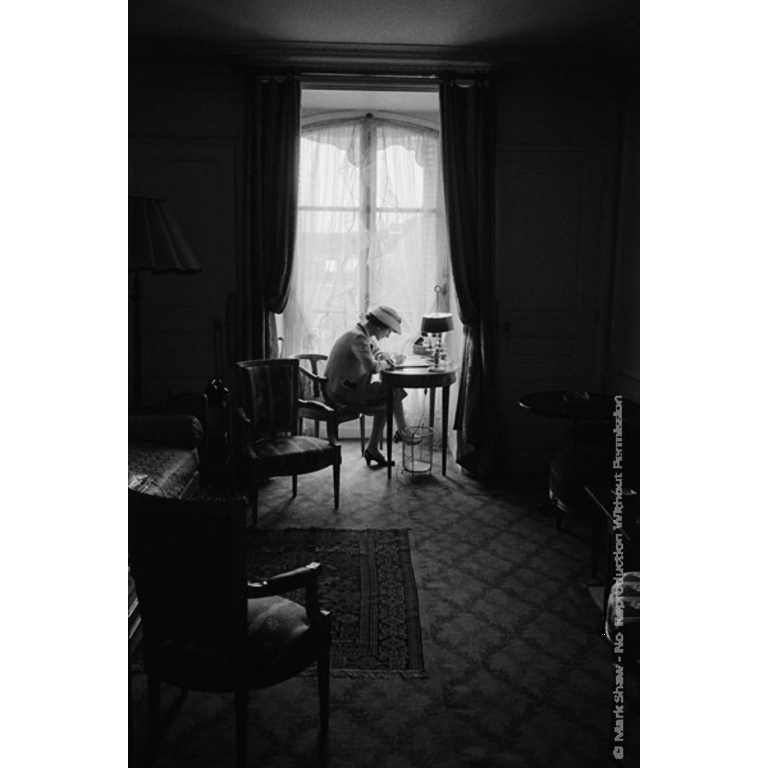 Mark Shaw Photography Coco Chanel Writes at Desk in Window, Head Down