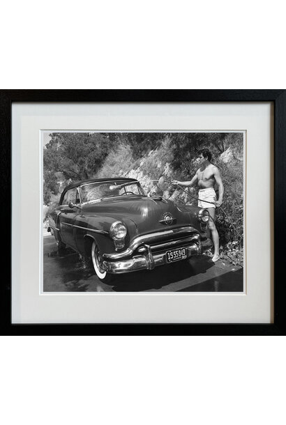 Sid Avery - Rock Hudson washing his 1952 Oldsmobile outside of his North Hollywood home 1952 - Black and white photograph - 11x14" - Black timber frame with non-reflective glass