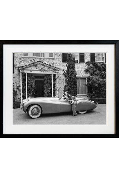 Sid Avery - Humphrey Bogart, Lauren Bacall and their son, Stephen, in their Jaguar XK 120 at home in Los Angeles, CA 1952 - Black and white photograph - 16x20" - Black timber frame with non-reflective glass