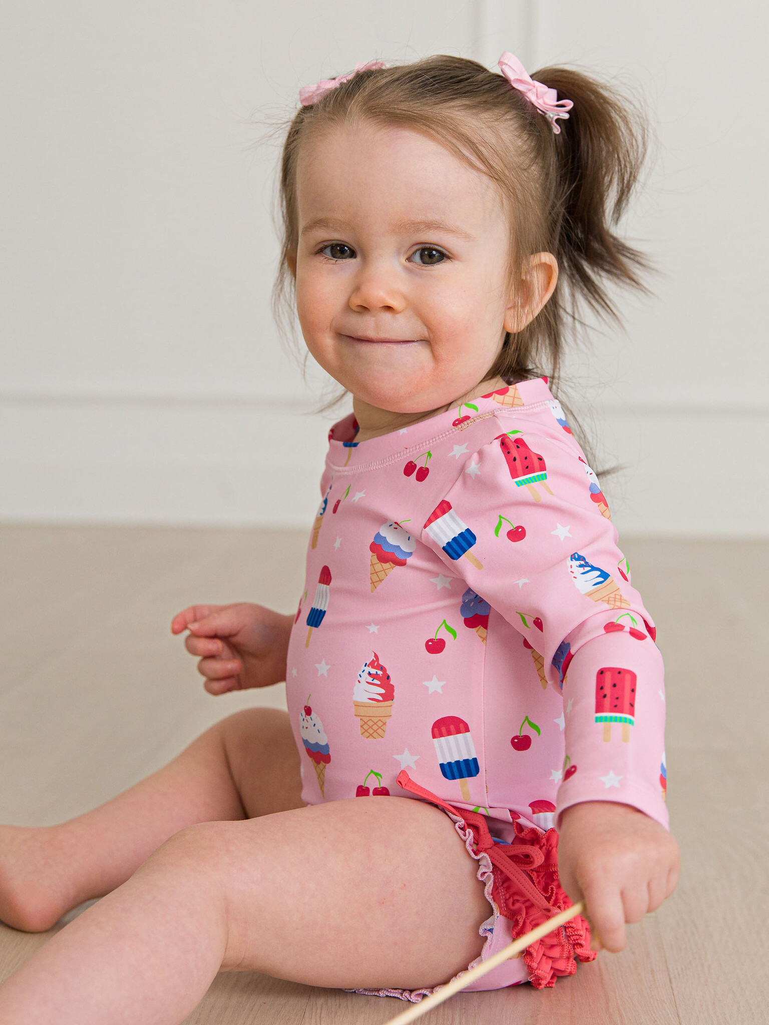 RuffleButts Rufflebutts Sweet Freedom Long Sleeve One Piece Rash Guard