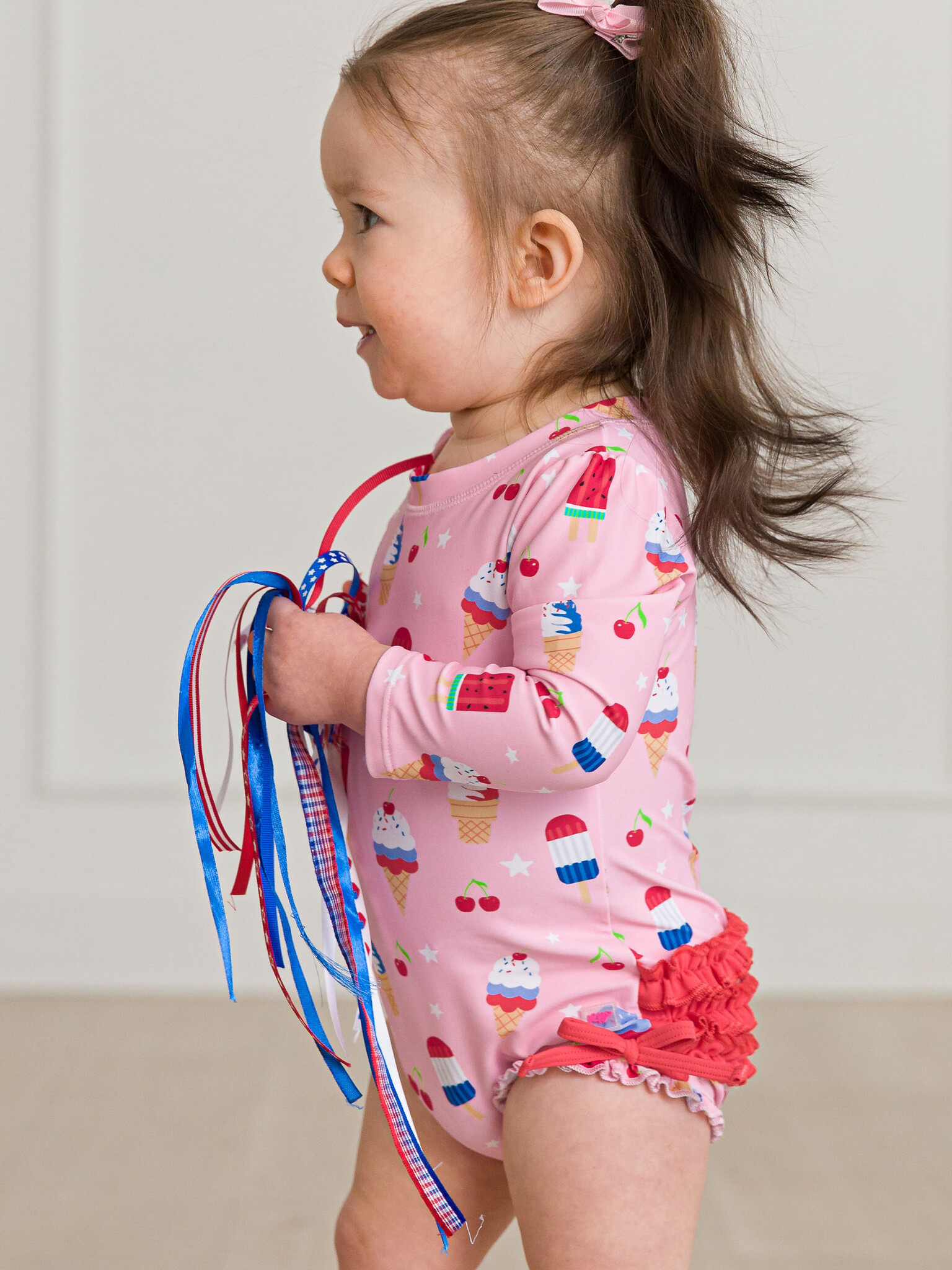 RuffleButts Rufflebutts Sweet Freedom Long Sleeve One Piece Rash Guard