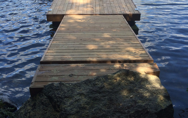 Dock installation on rocky shoreline