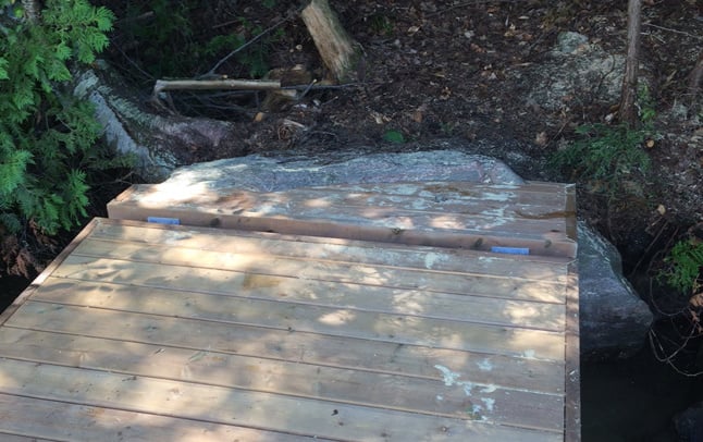 Dock installation on stone shoreline