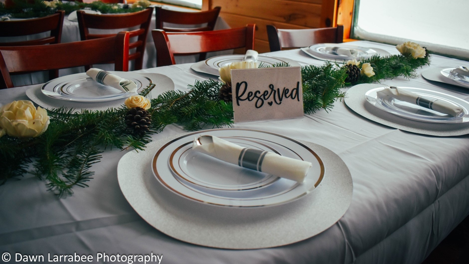 Table with plates set at it in lodge.