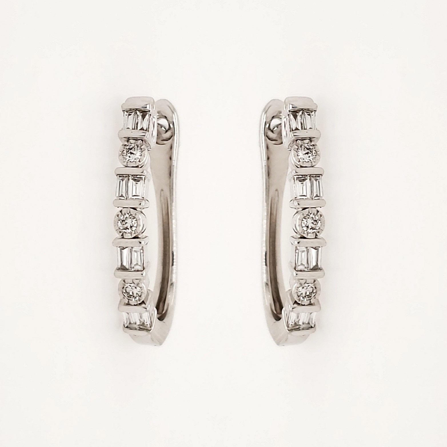 30557 10K WHITE GOLD .25CTW DIAMOND BAGUETTE AND ROUND OVAL EARRINGS