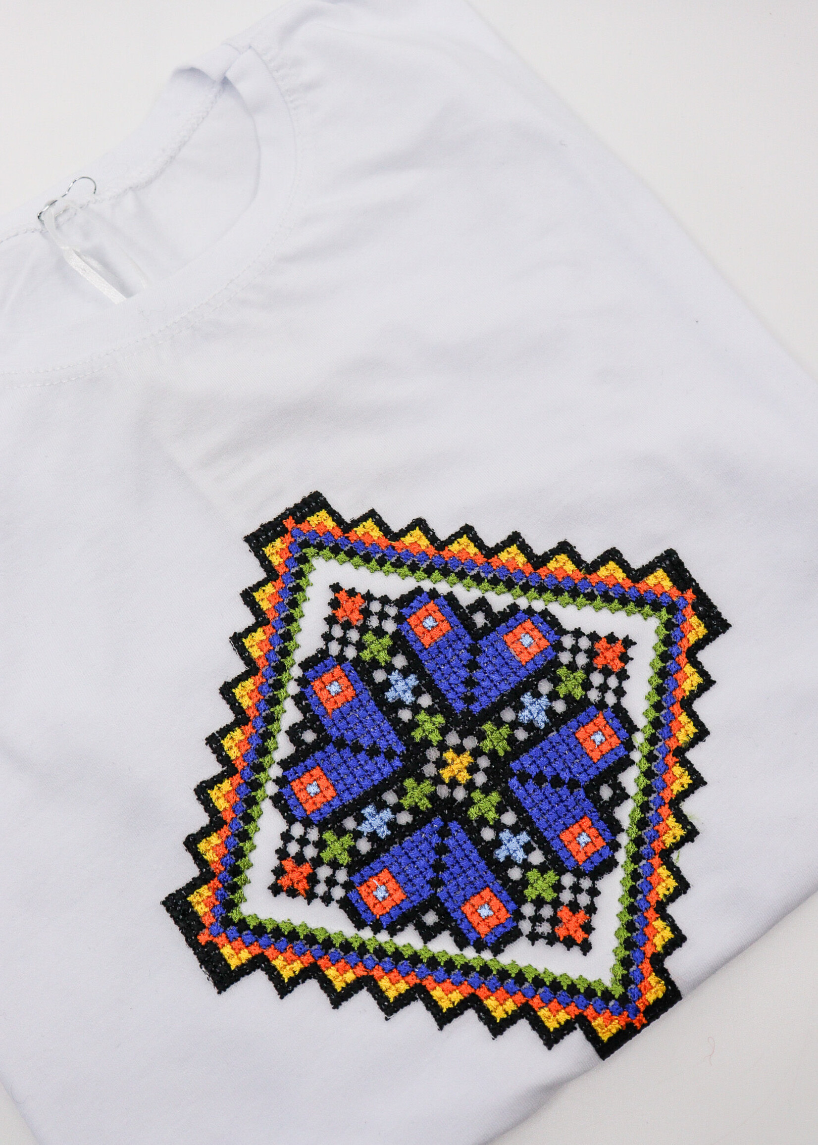 APPAREL - White T-Shirt (W), with a diamond shaped colorful embroidery