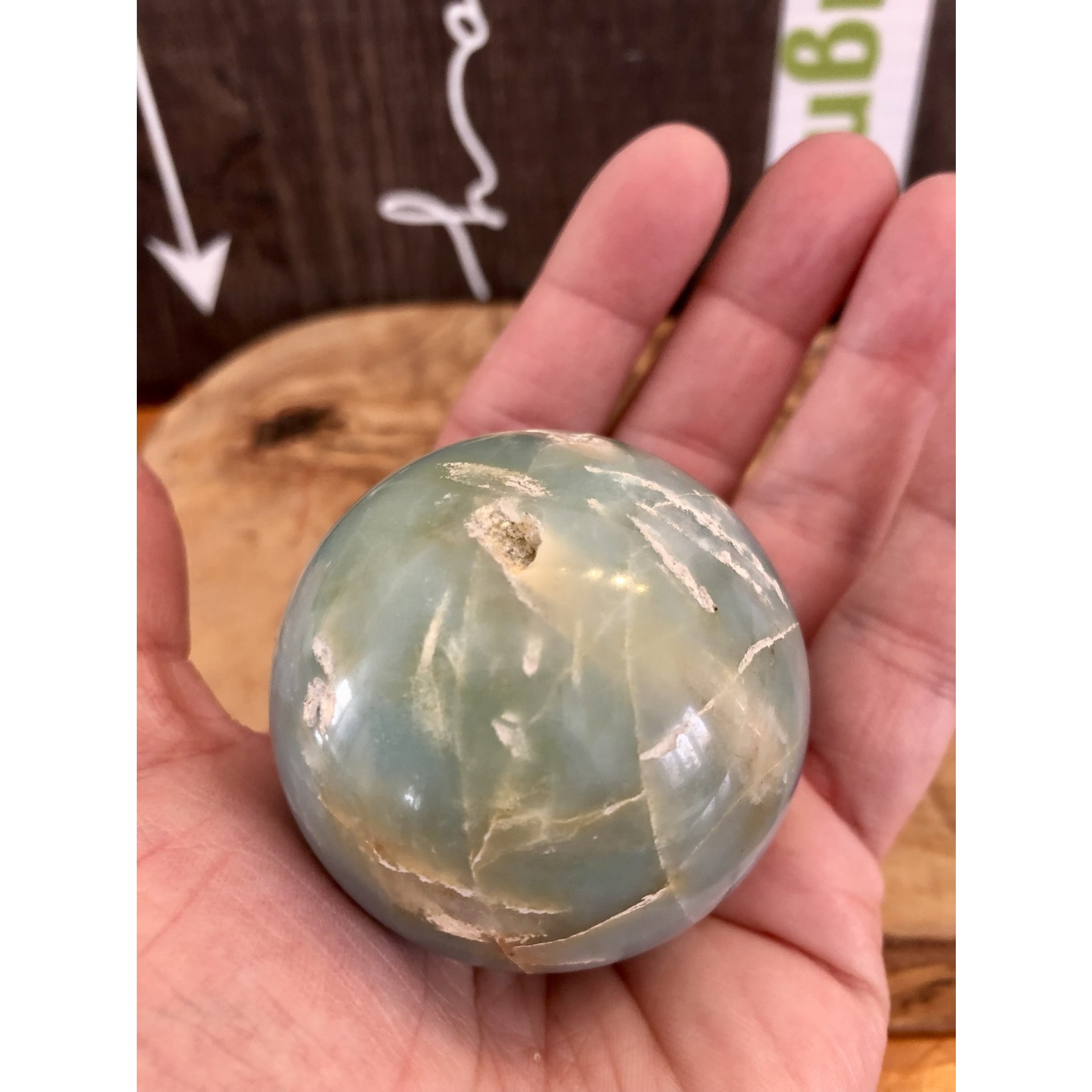 large caribbean calcite sphere, looks like a globe, purifies and aligns the chakras, balances the yin and yang energies