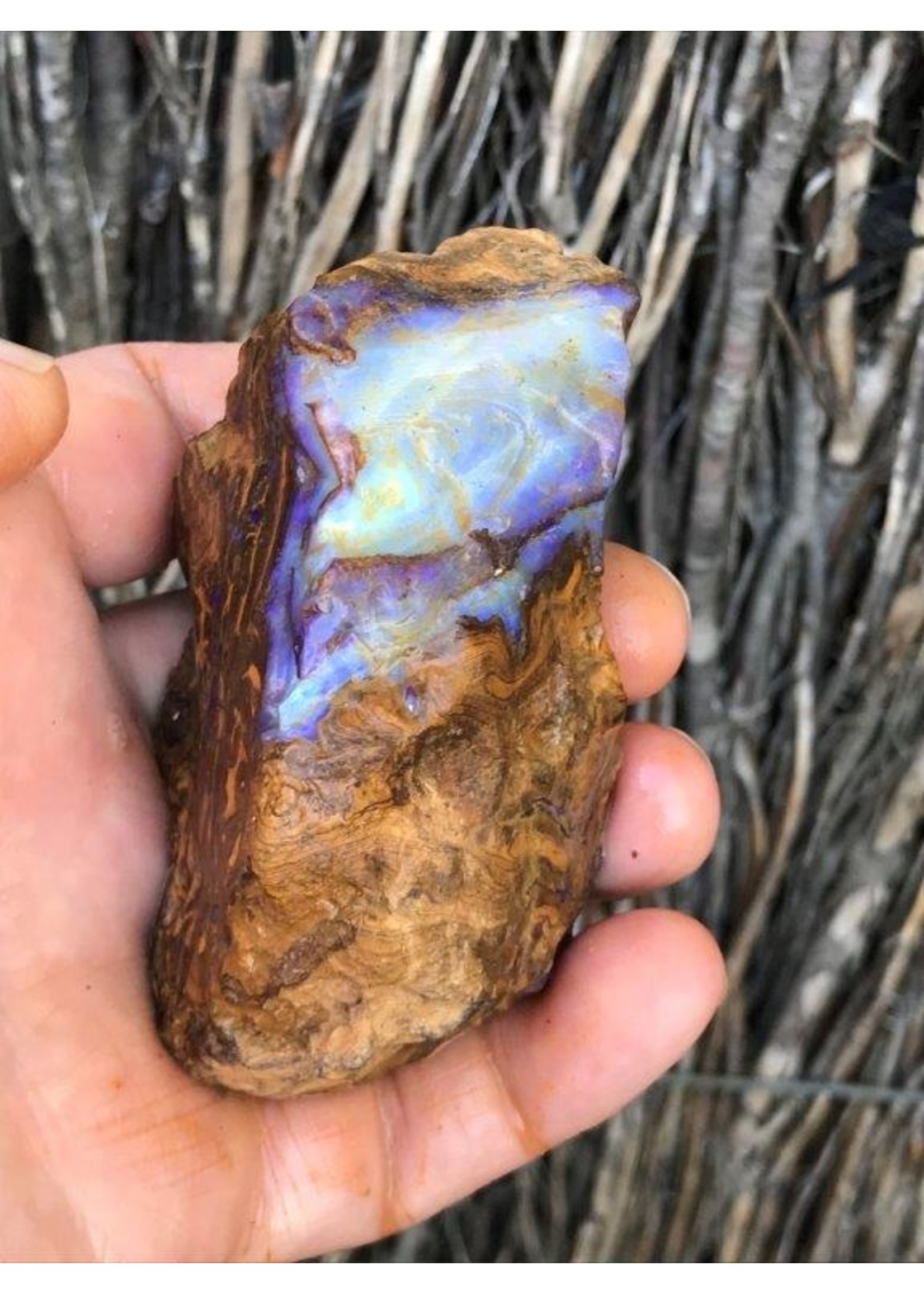 piece of boulder opal purple, symbolizes light, hope, appeasement and harmony