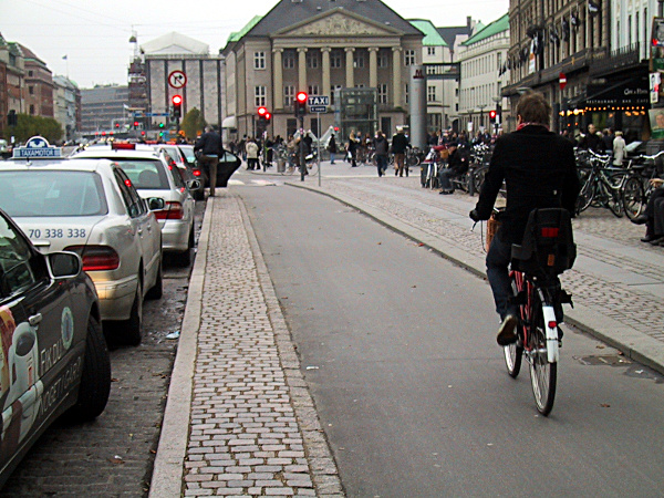 A cycletrack in Copenhagen, Denmark. Notice how everything else on the street is made with cobblestone except the smooth path for bikes? Photo credit: peopleforbikes.org 