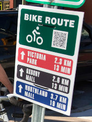 One of the Bird wayfinding signs, displays different locations and the distance to them and approximately how many minutes it takes by bike.
