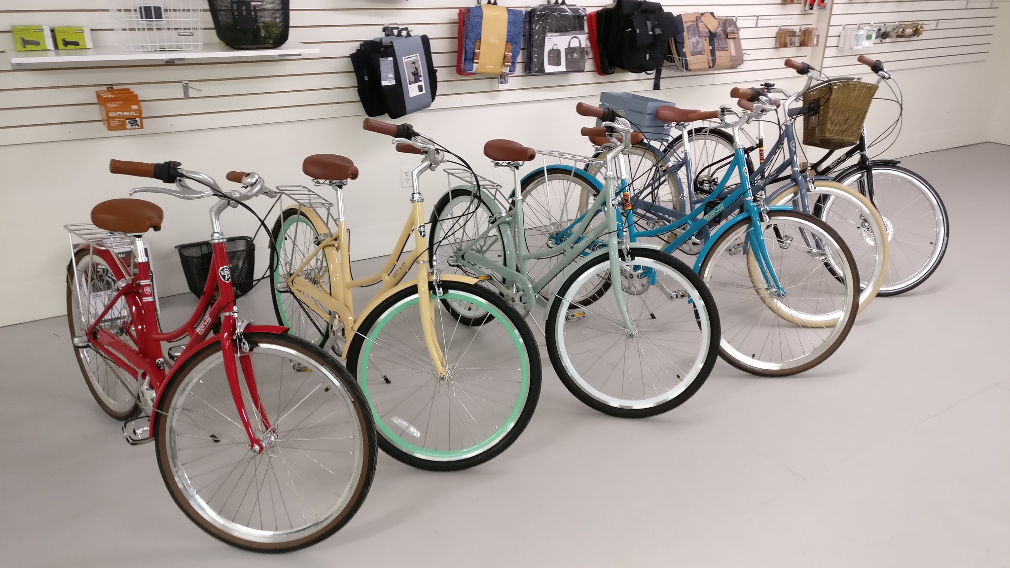 A colorful lineup of step through bicycles.