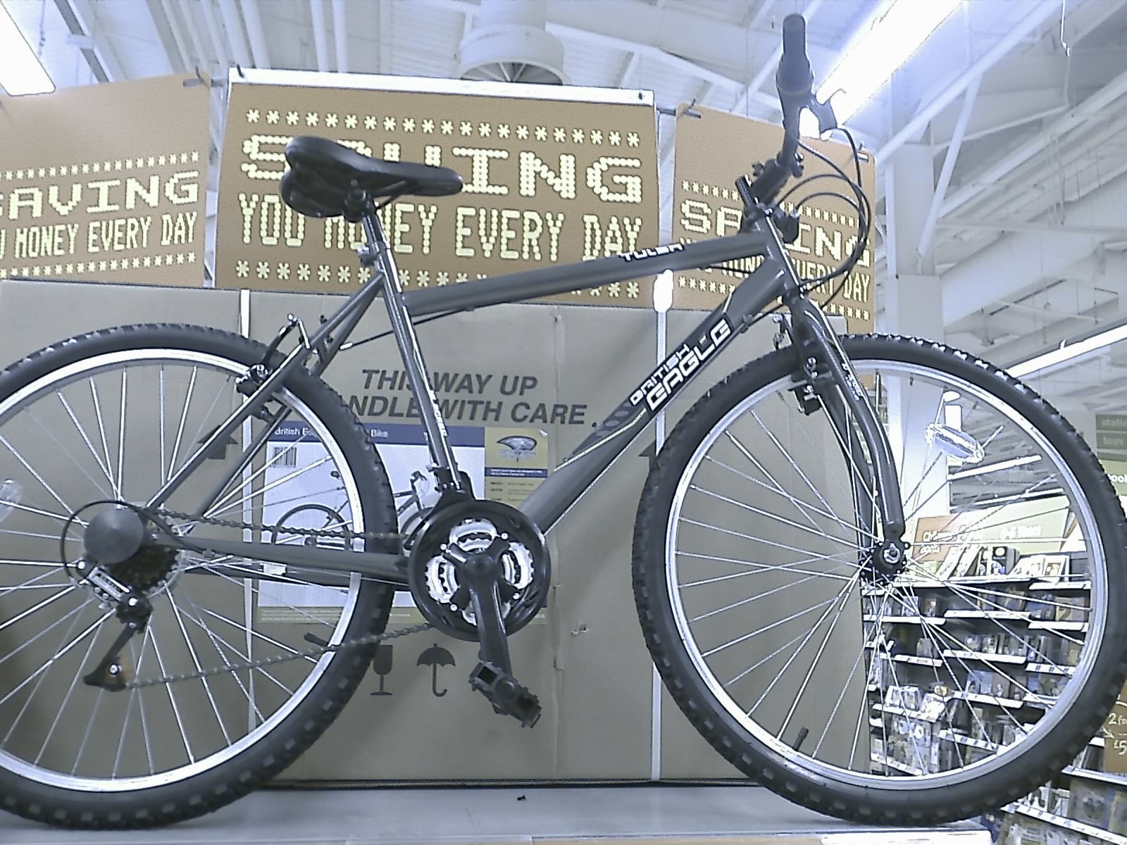 A department store bike on display with the front fork installed backwards.