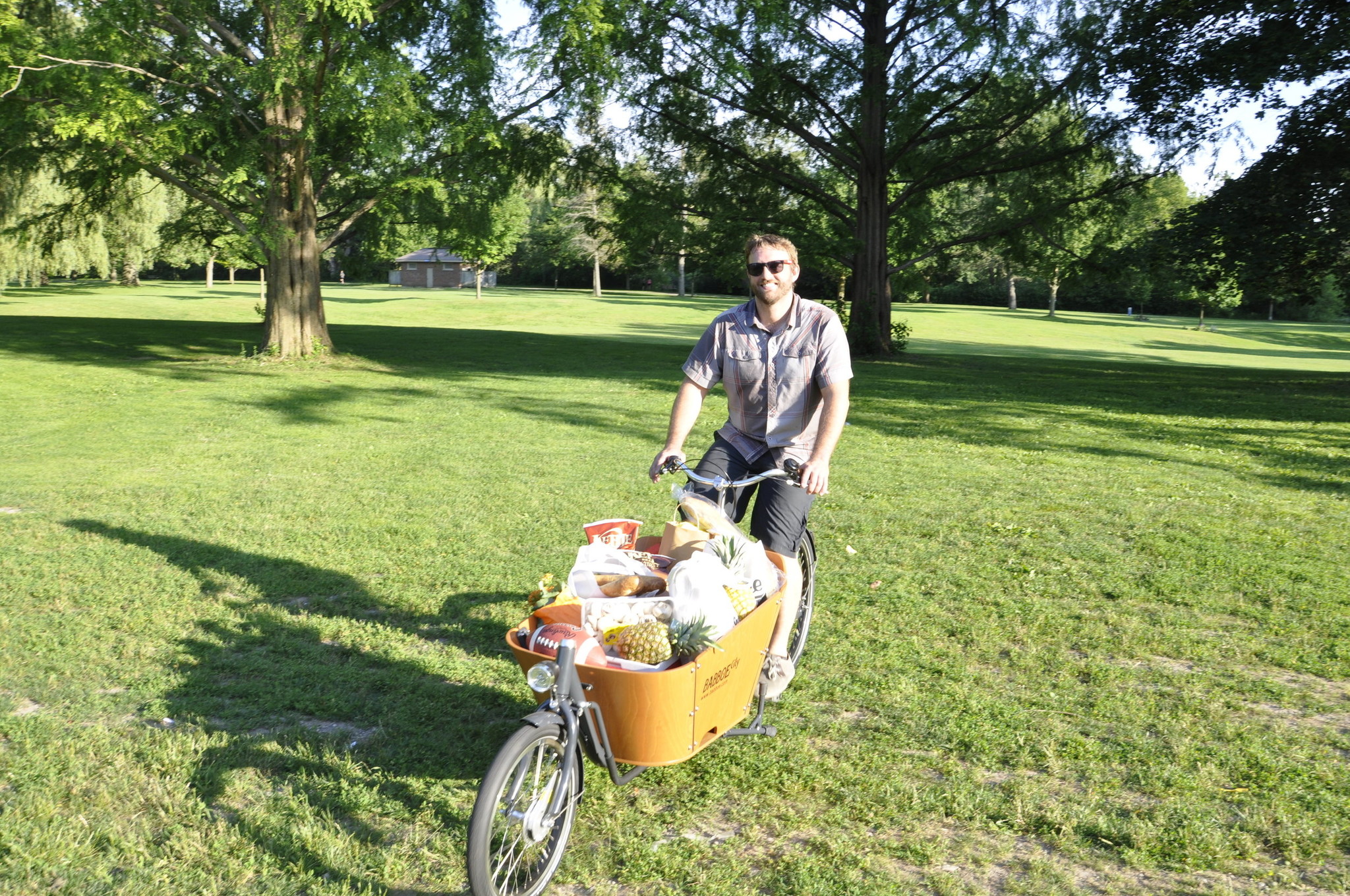 Ben rides a bakfiets; box bike, full of picnic supplies.