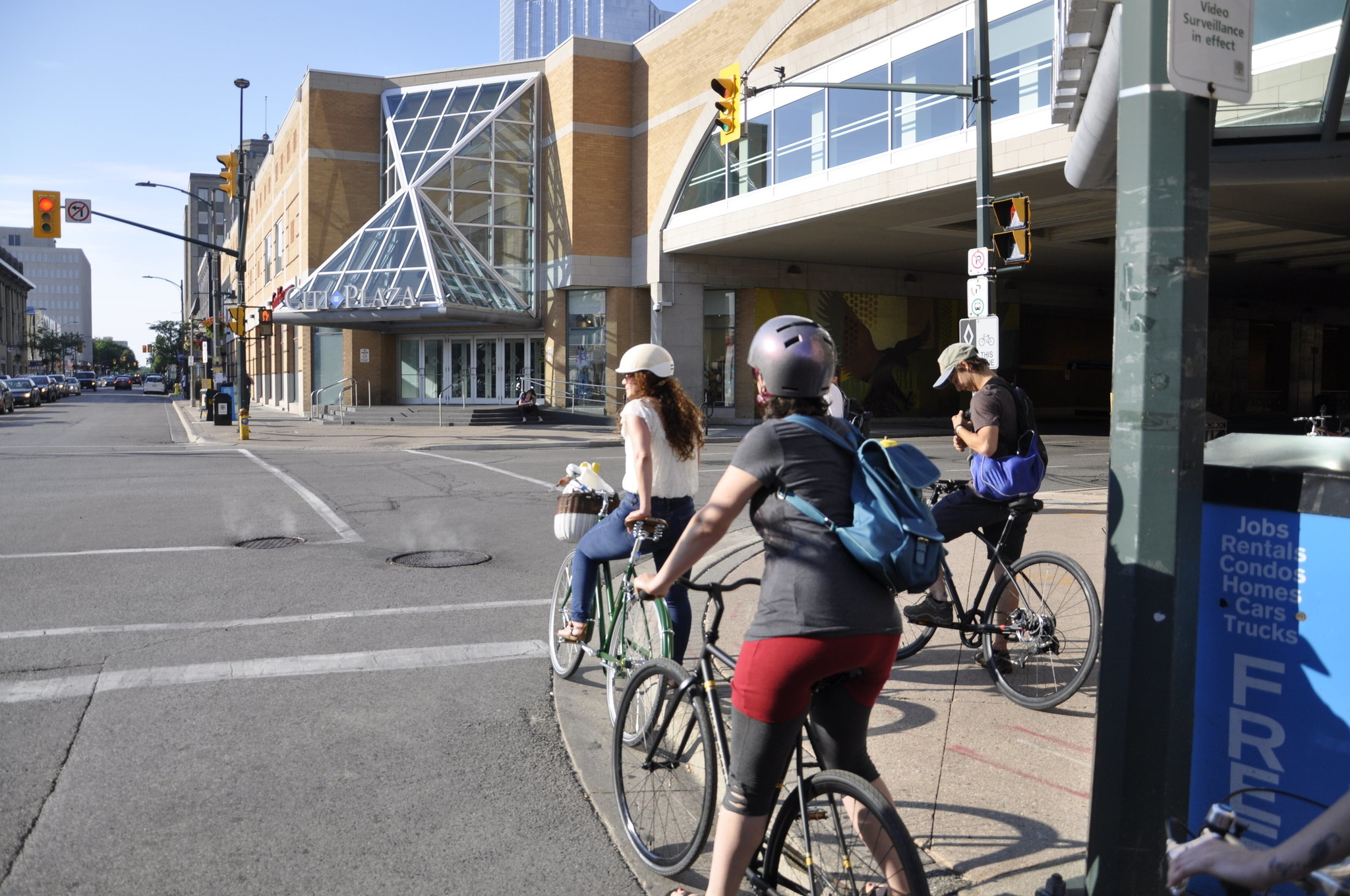 Several cyclists wait for a street light to change along their route.