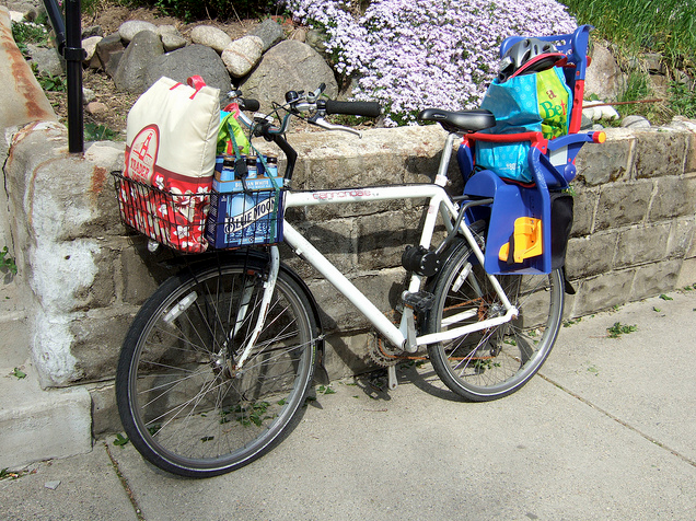 A bicycle loaded up with groceries.