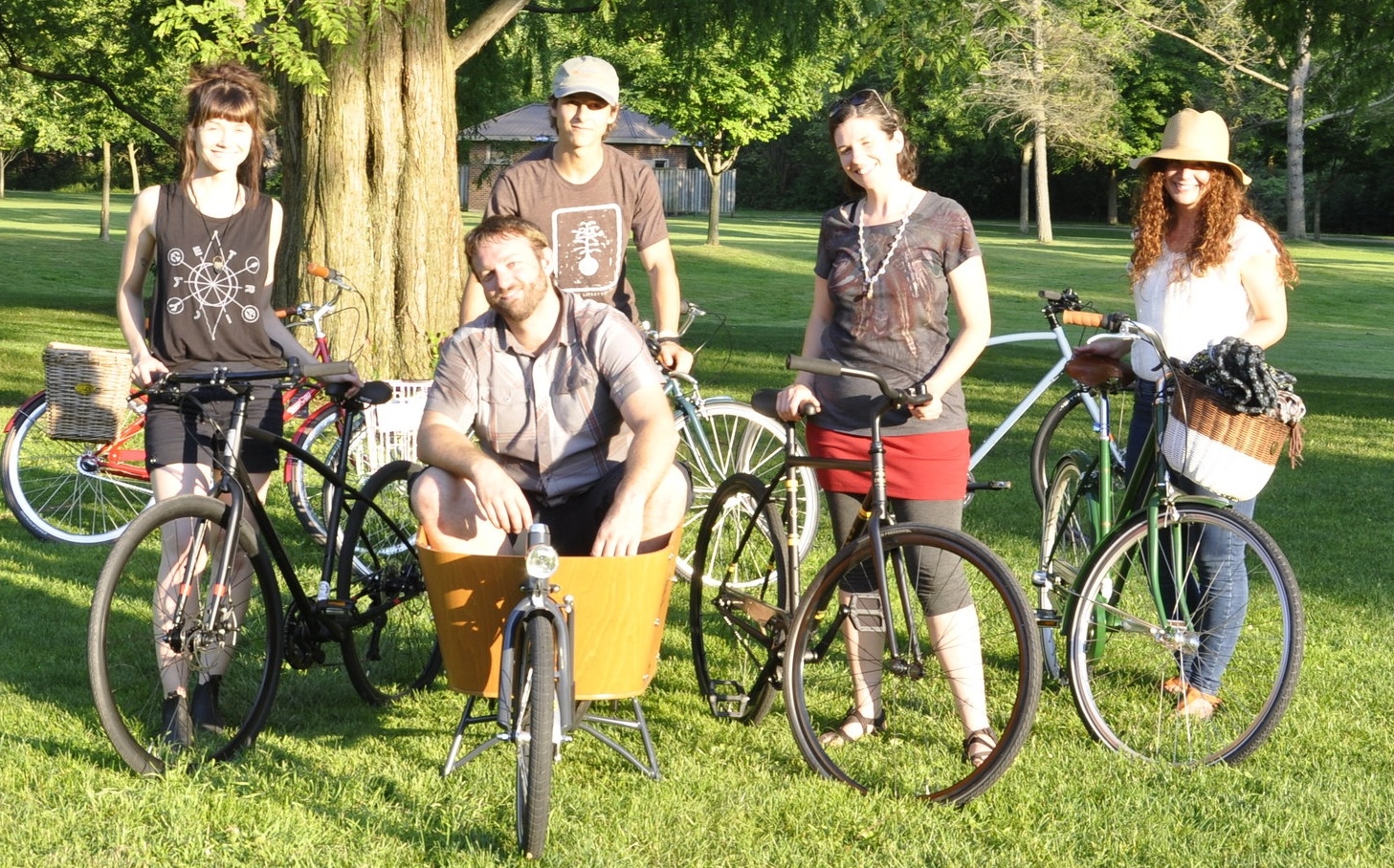 Ben sits in the Babboe bakfiets box, centre, surrounded by friends and their bikes.