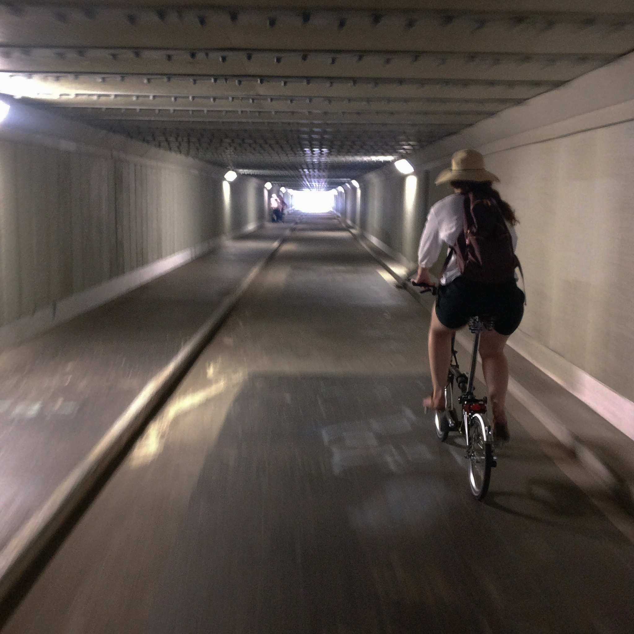 Caroline rides her Brompton bike in the tunnel.