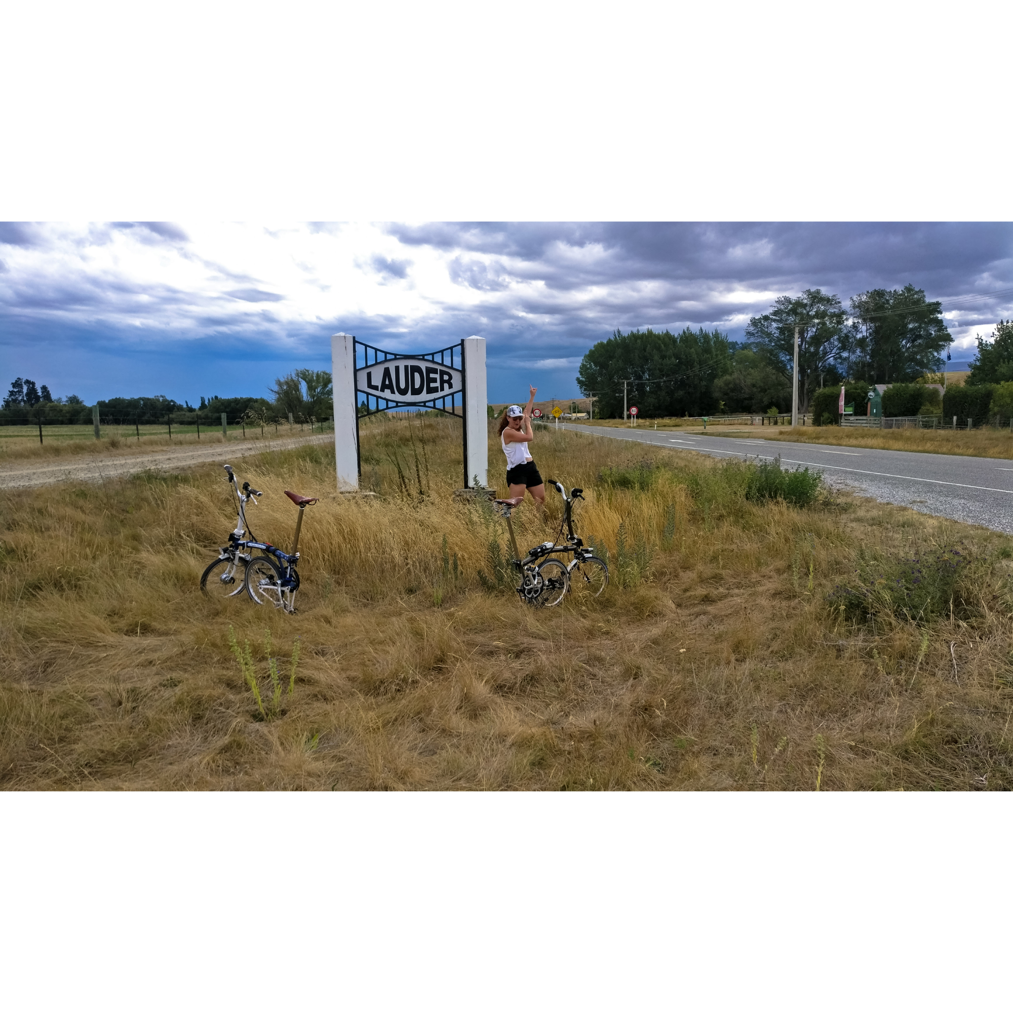 Caroline in some brush in front of a sign that says Lauder.