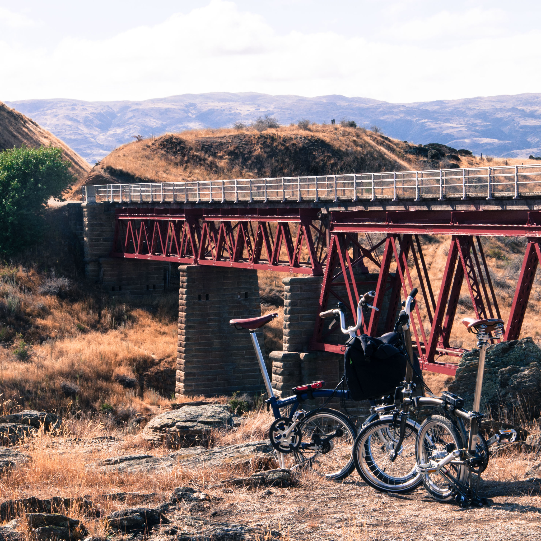 The Bromptons folded, beyond is the rail bridge.