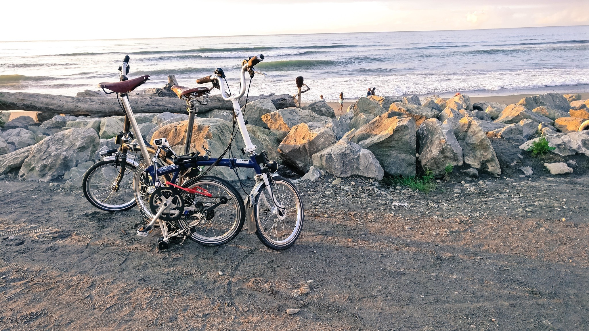 Two Bromptons on a beach