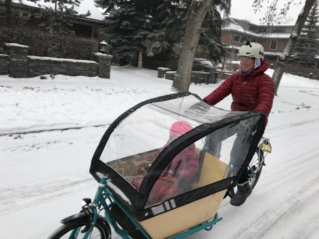 A box bike being ridden in the winter