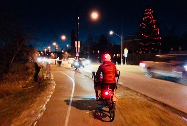 A box bike from behind at night.