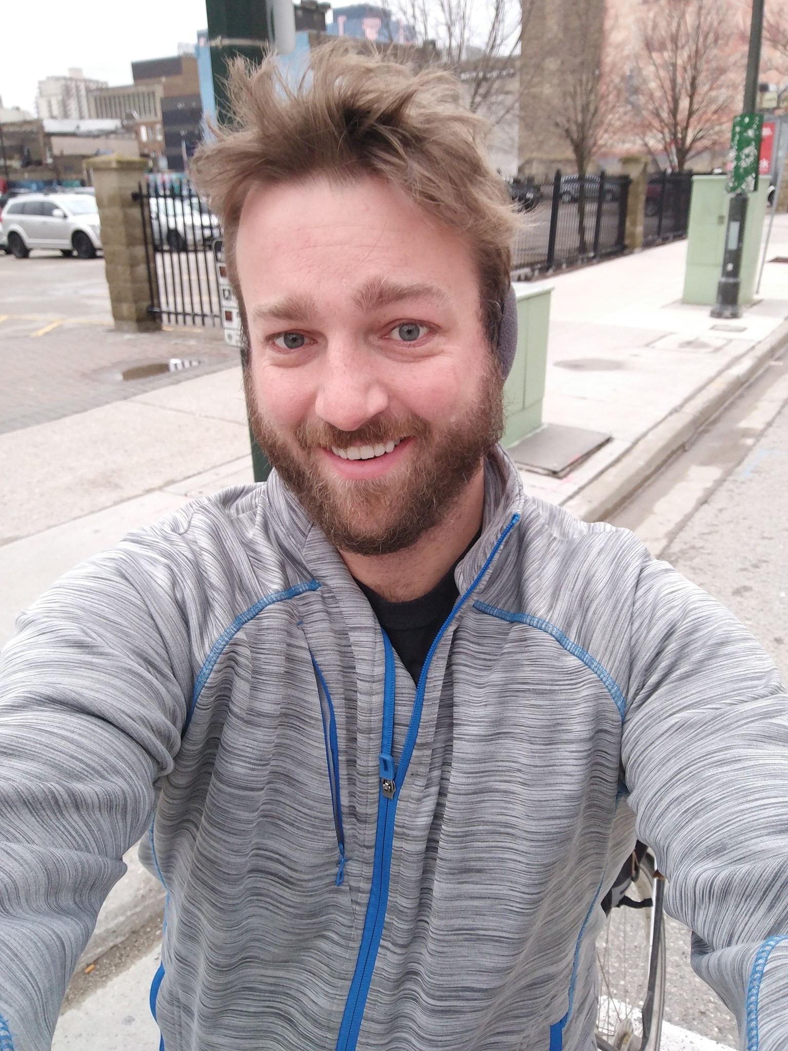 Ben smiles as he takes a selfie with the wind in his hair around his earmuffs.