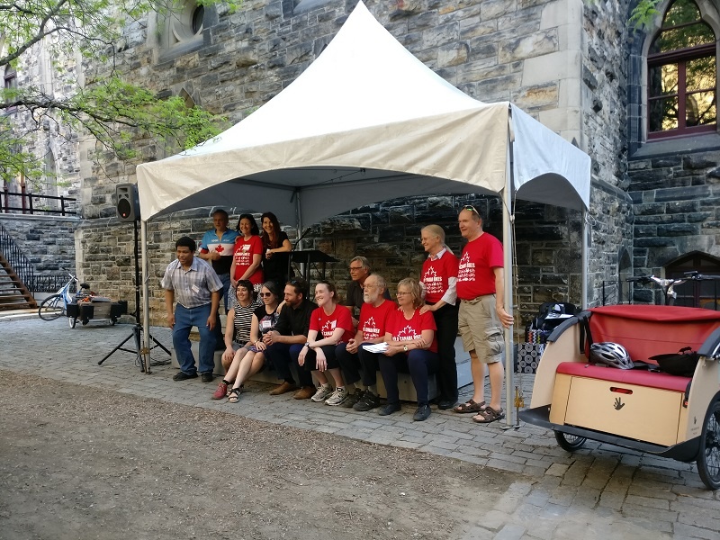 Board of directors of Velo Canada Bikes under an awning outside