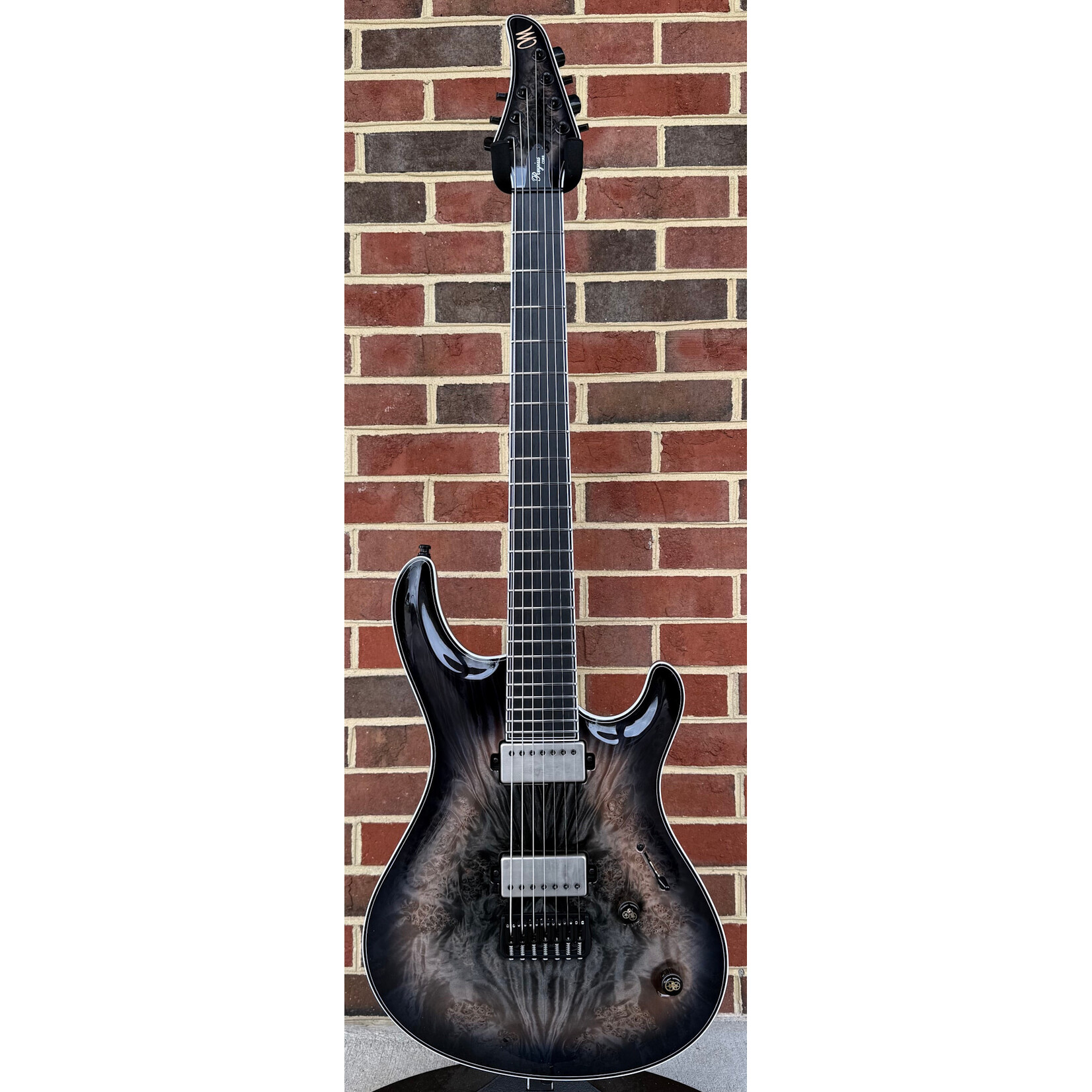 Mayones Mayones Regius Core 7 B26.5, Galaxy Eye Black, 5A Maple Burl Top, Black Limba Body, 11pc Wenge/Mahogany/Purpleheart/Maple Neck, Ebony Fretboard, Hipshot Bridge, Clockwork Knobs, Velvetrone Ironside + Solium Pickups, Mayones Hybrid Double Deck Case