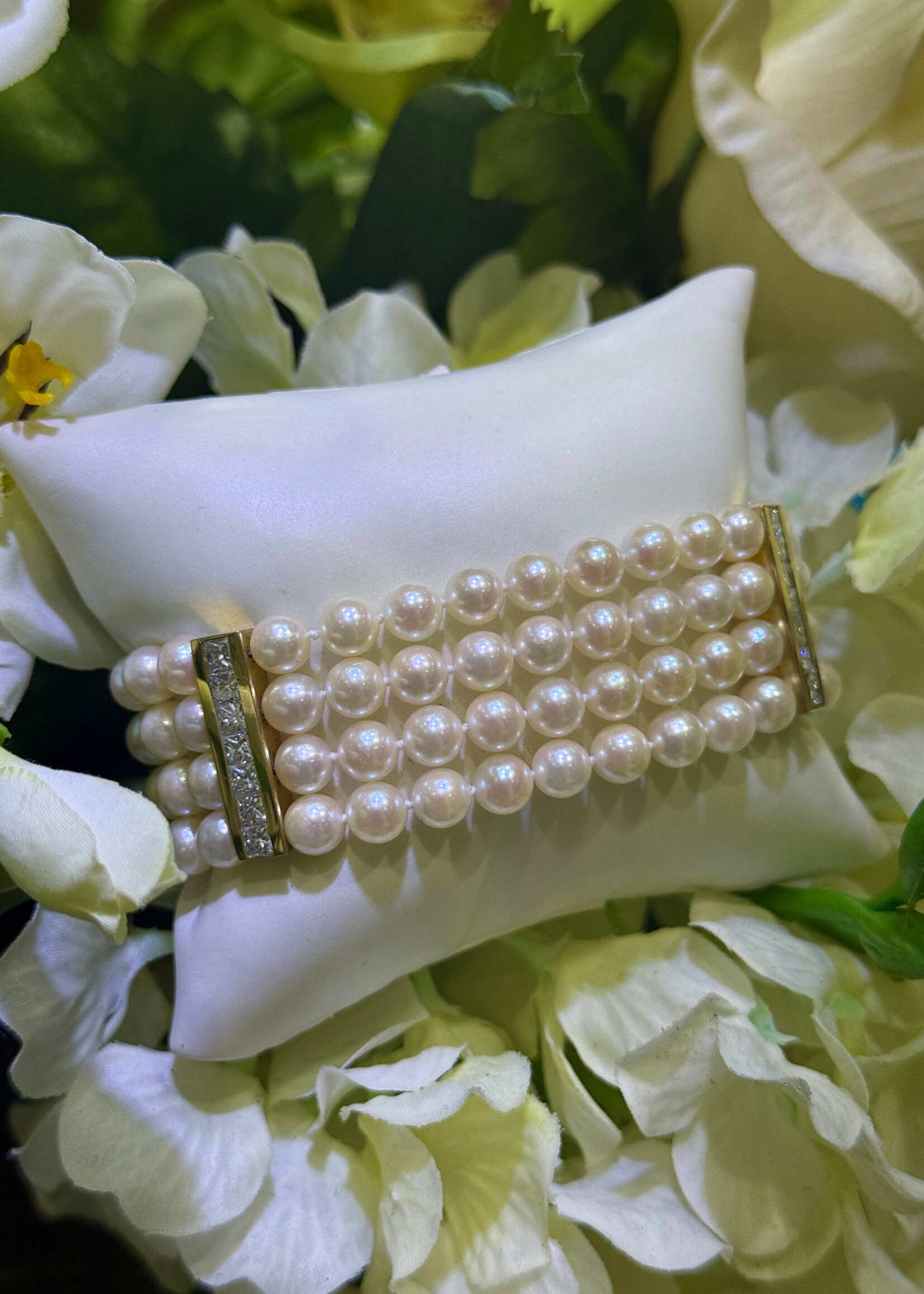 18k yellow gold four strand Pearl Bracelet with approximately 2.10 carats of princess cut diamonds.