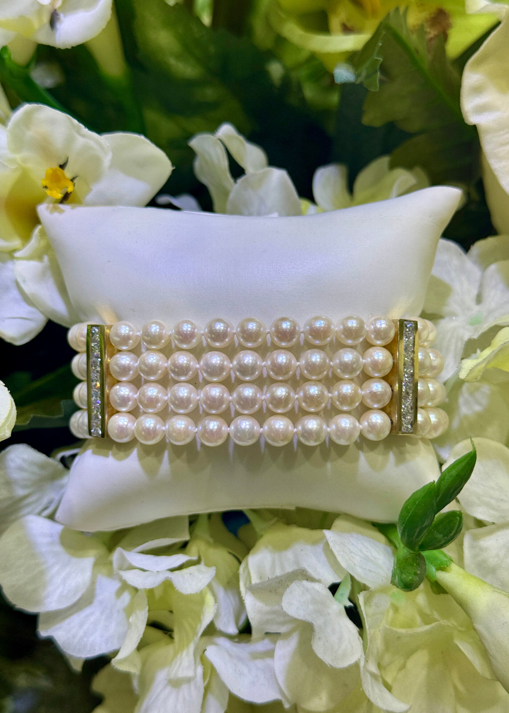 18k yellow gold four strand Pearl Bracelet with approximately 2.10 carats of princess cut diamonds.