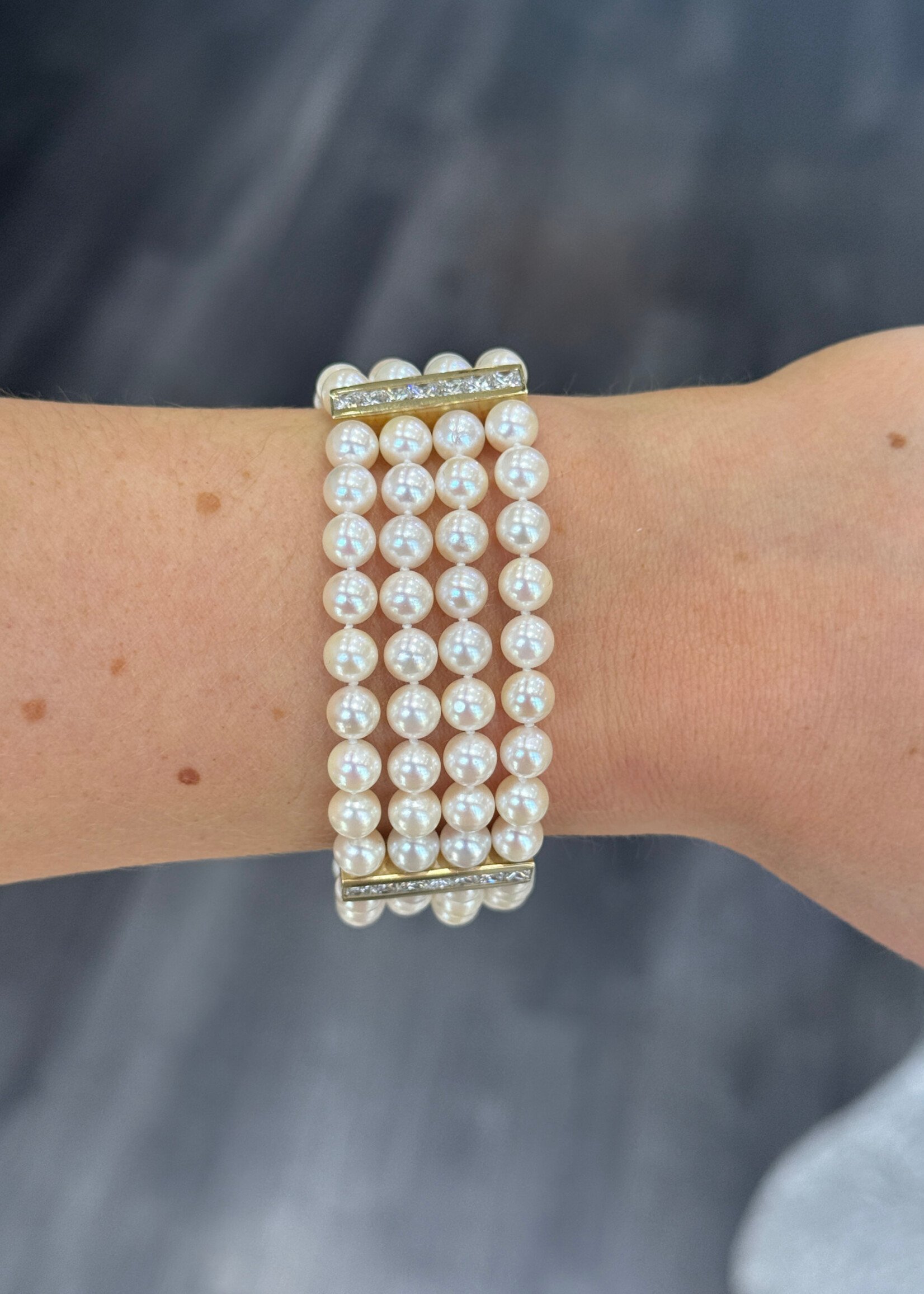 18k yellow gold four strand Pearl Bracelet with approximately 2.10 carats of princess cut diamonds.
