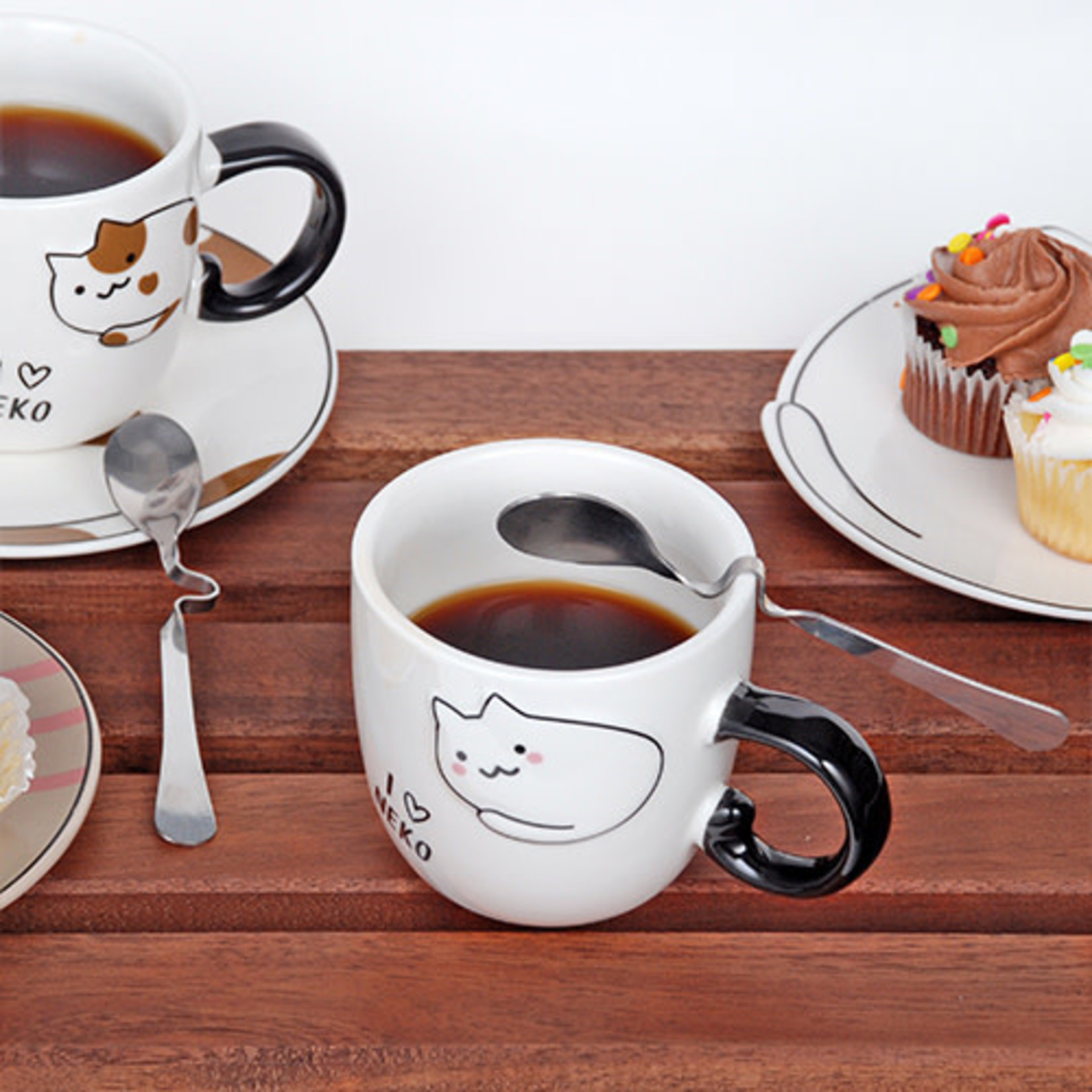 Slice of Sacher cake in plate with coffee cup and kettle in background  stock photo