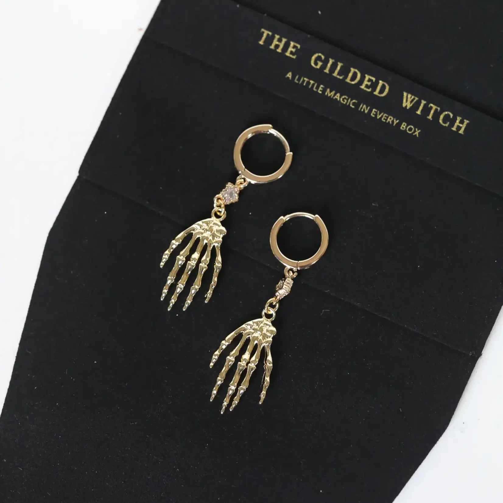 Skeleton Hand Huggie Earrings · Gold