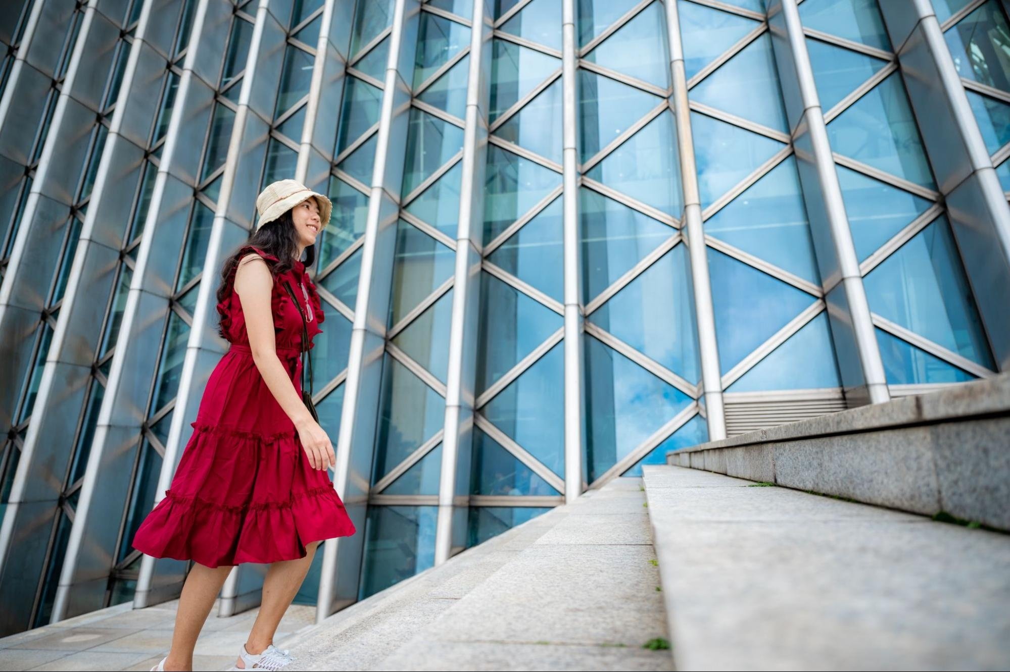 Woman in a tiered dress walking up stairs. 
