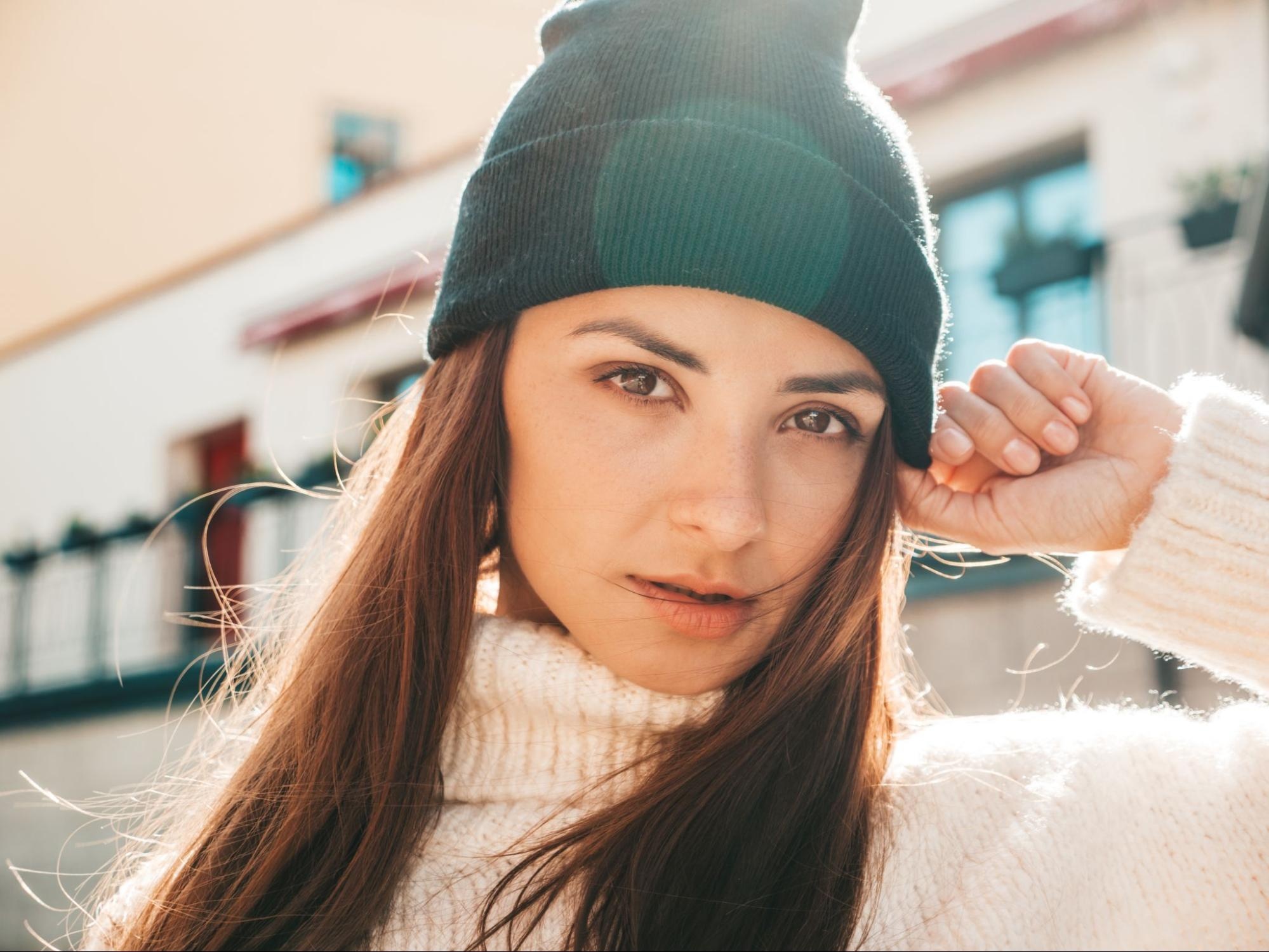 Woman posing in a beanie. 