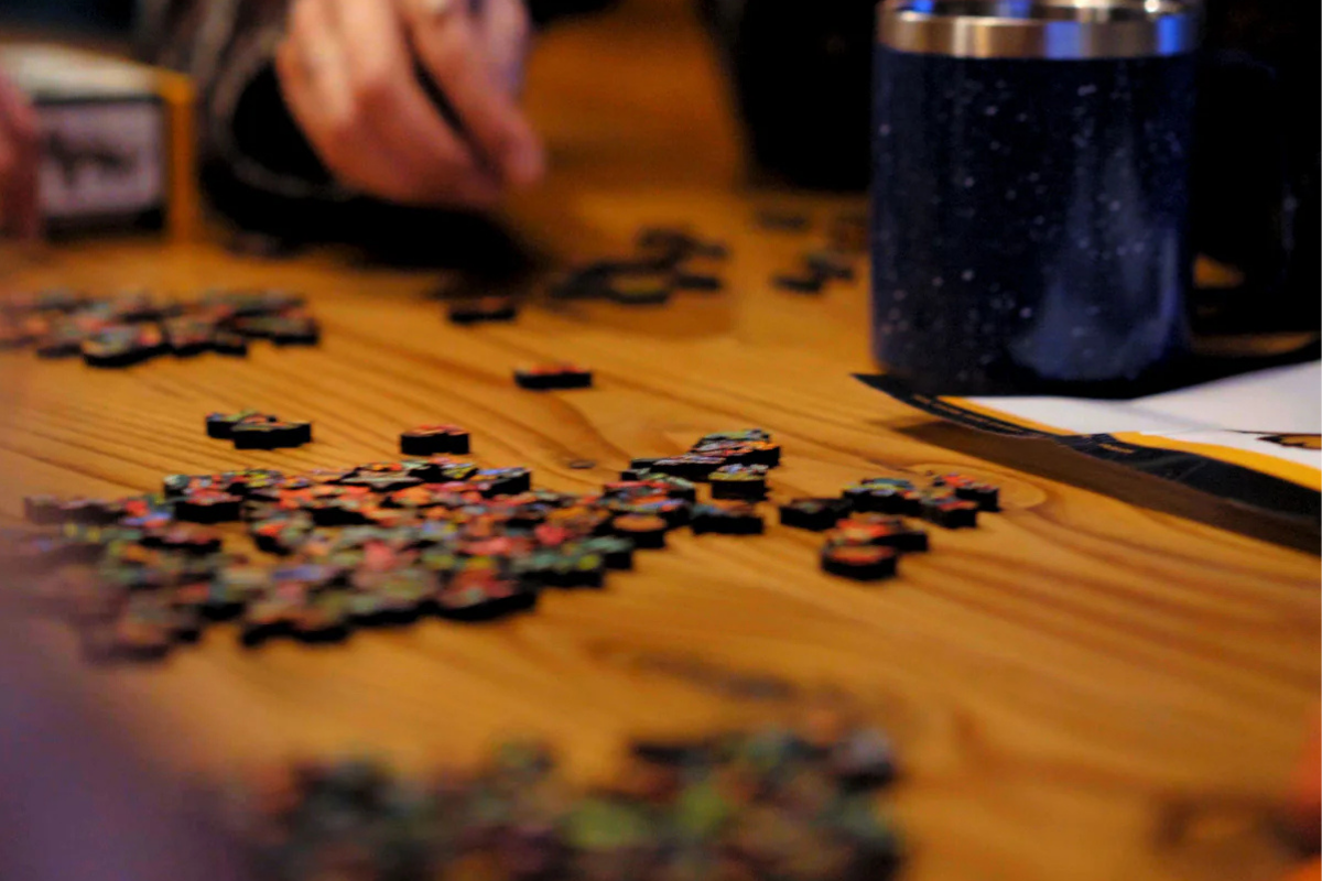 person putting together a puzzle