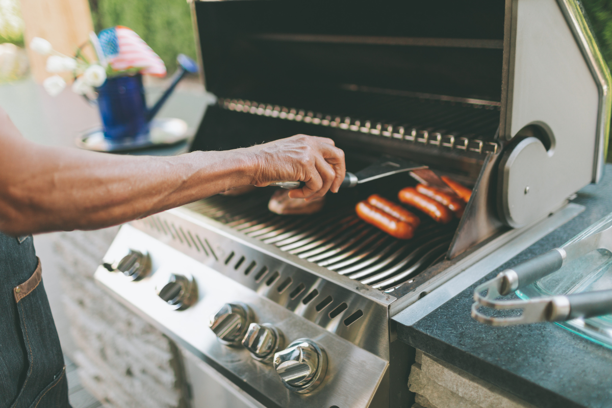 Man grilling meat on grill
