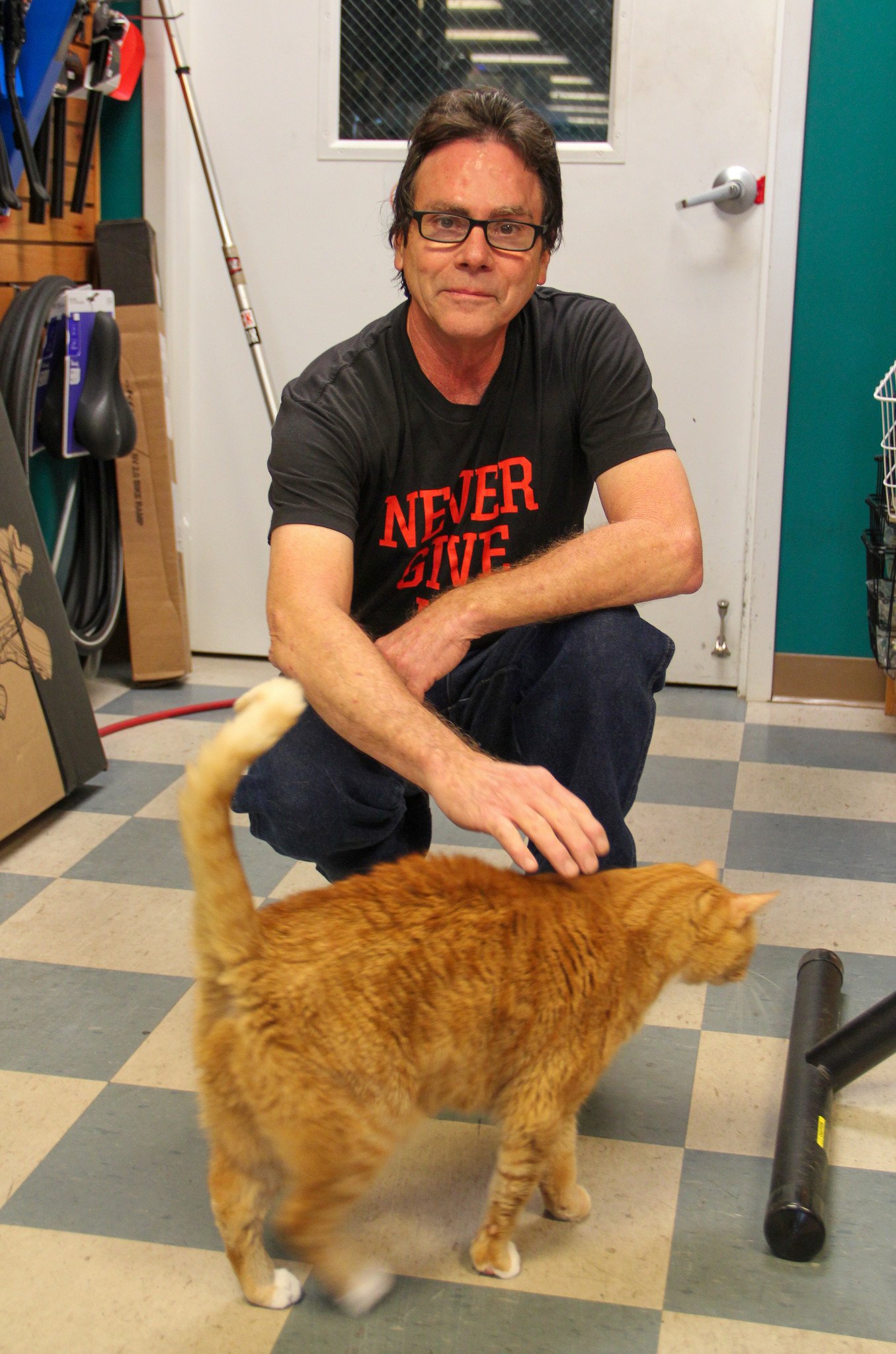 Photograph of Tommy Sager with shop cat Bubba