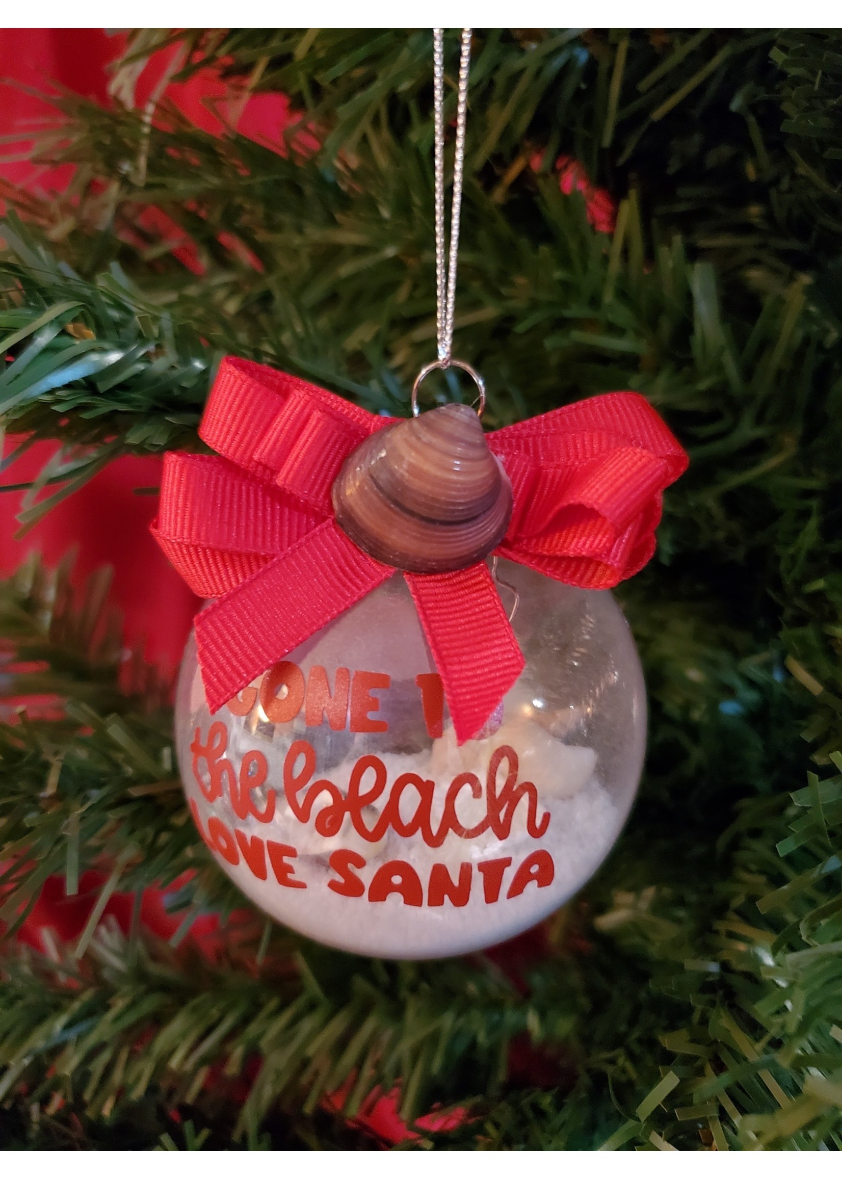 Sally Ward Ornament clear plastic 2.65 in-Red Gone to Beach w/Sand, Shells  and Red Ribbon