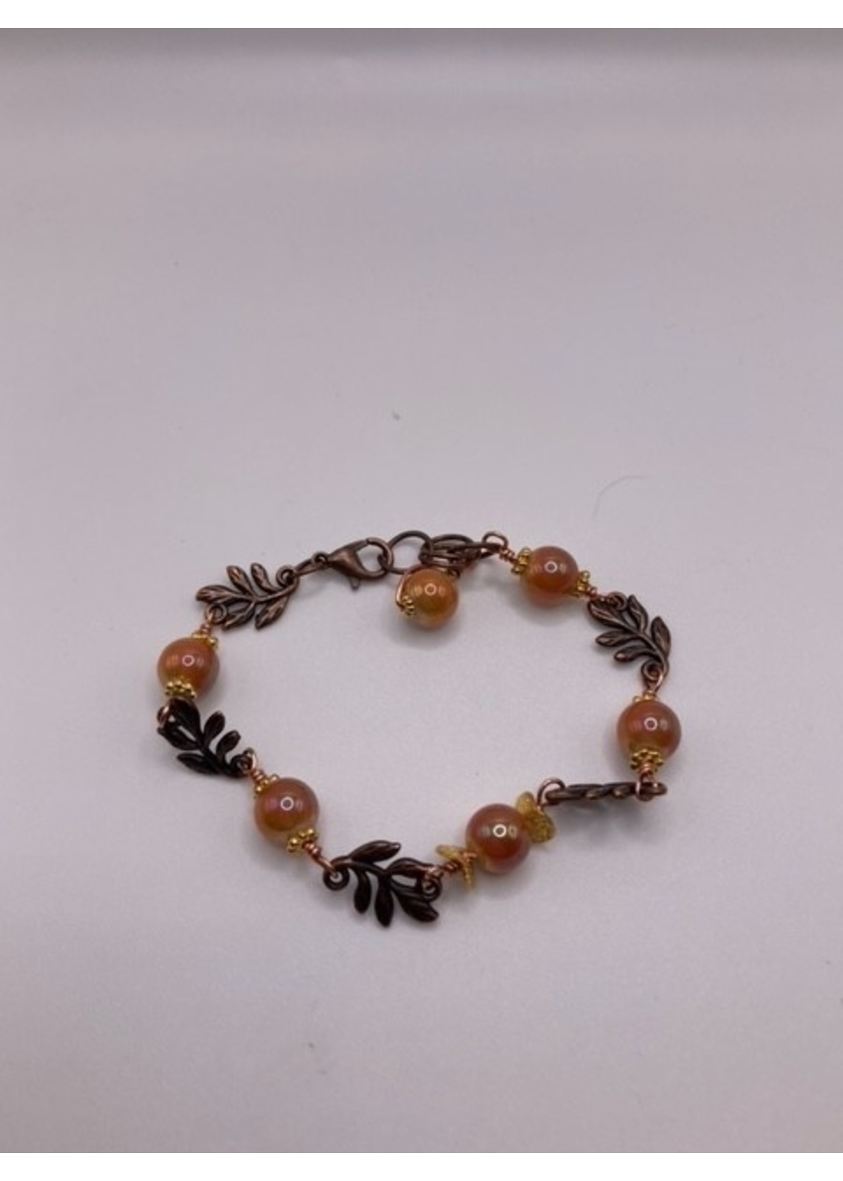 Our Twisted Dahlia Bronze Leaf Bracelet with Gold spacer Beads and Orange Pearl Sheen