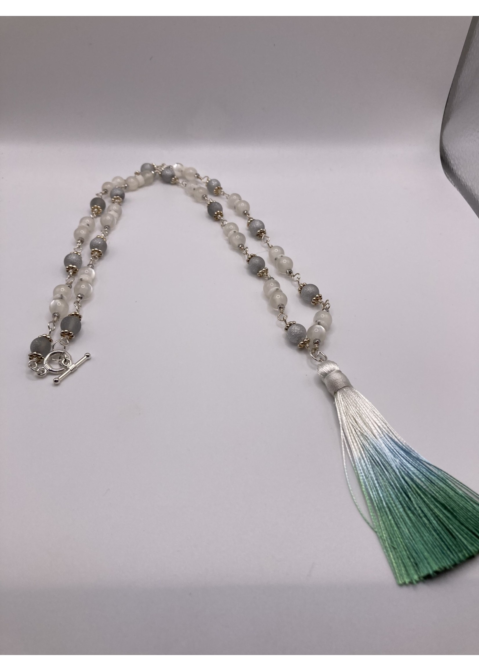 Our Twisted Dahlia N208 Milky White Cat’s Eye with Silver Findings, Heishi Beads, and Silk Tassle in White, Shades of Turquoise Necklace