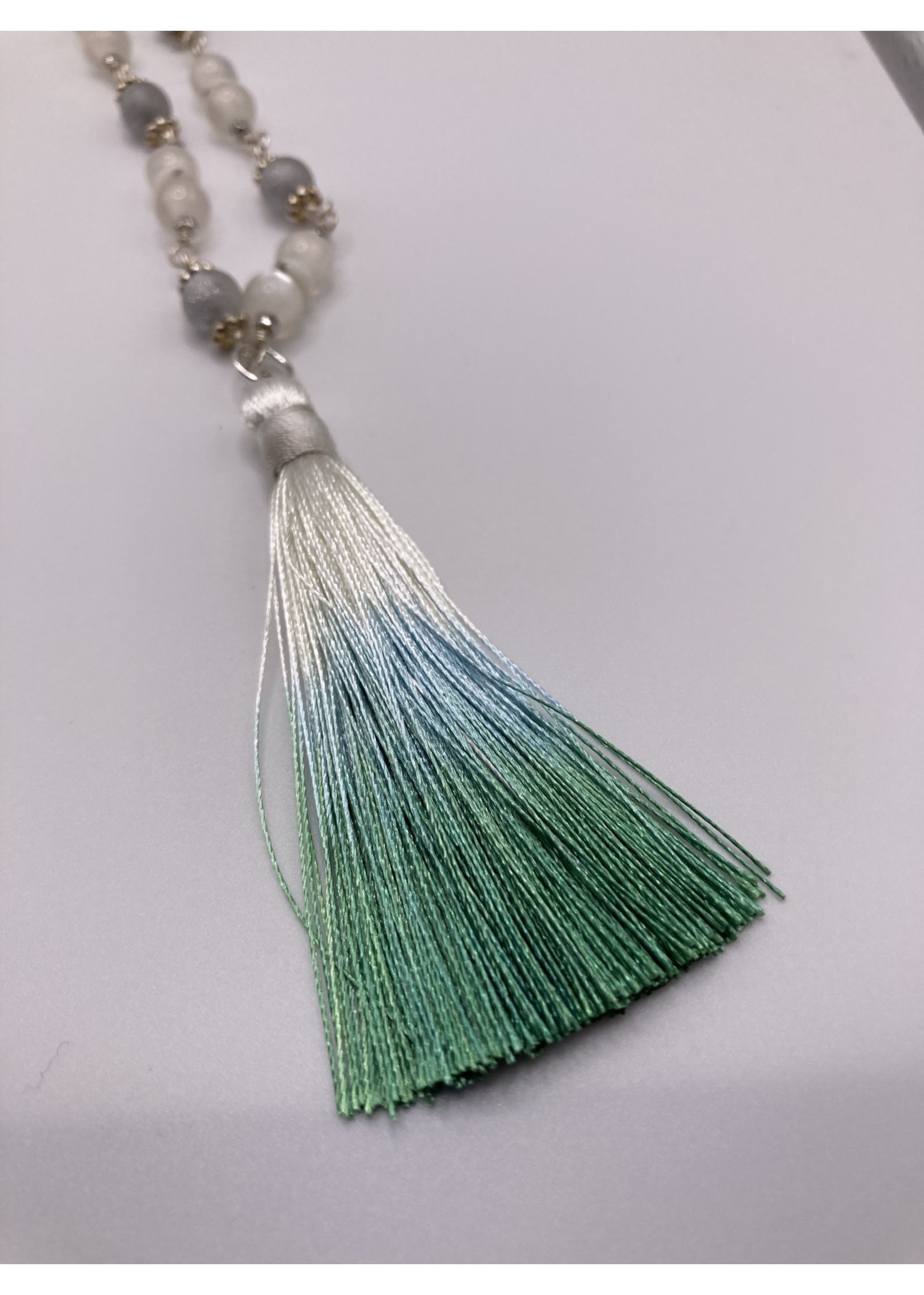 Our Twisted Dahlia N208 Milky White Cat’s Eye with Silver Findings, Heishi Beads, and Silk Tassle in White, Shades of Turquoise Necklace