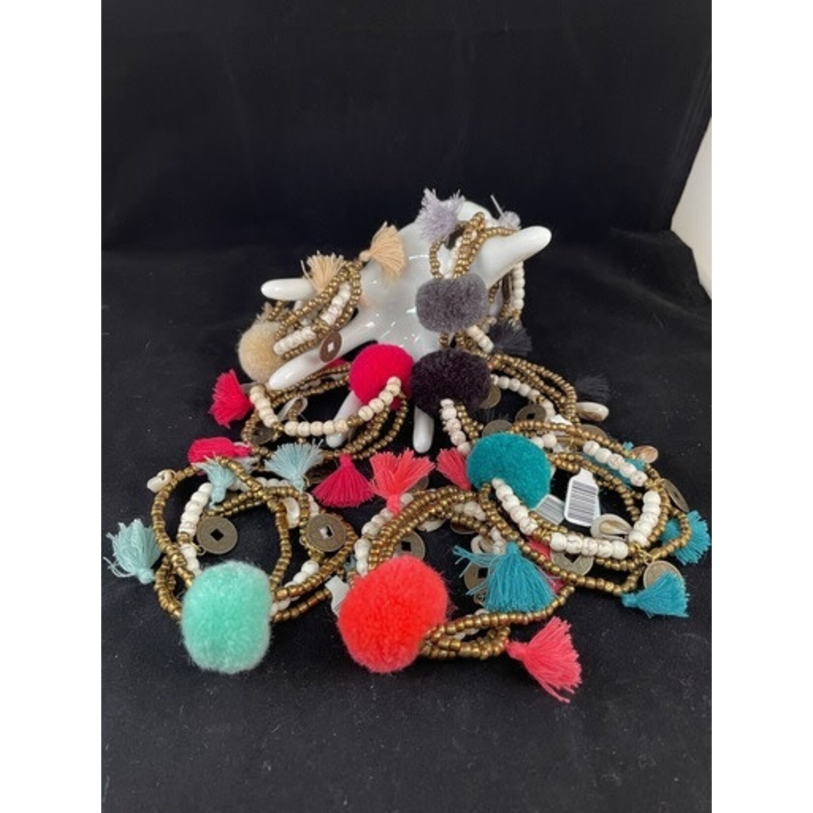 m. lynne designs cream big pom bracelet with tassels and coins